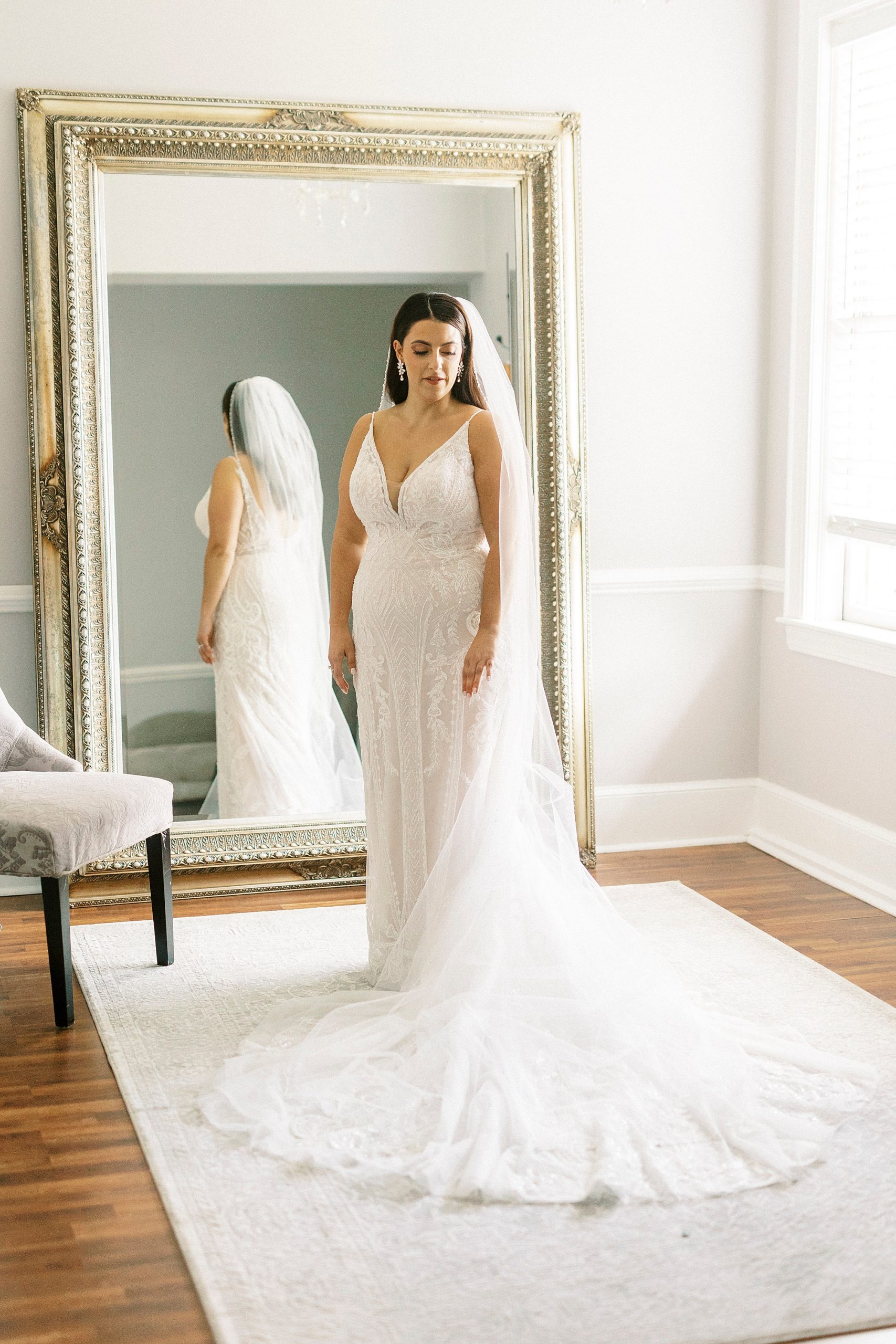 bride stands by mirror in bridal suite at Separk Mansion