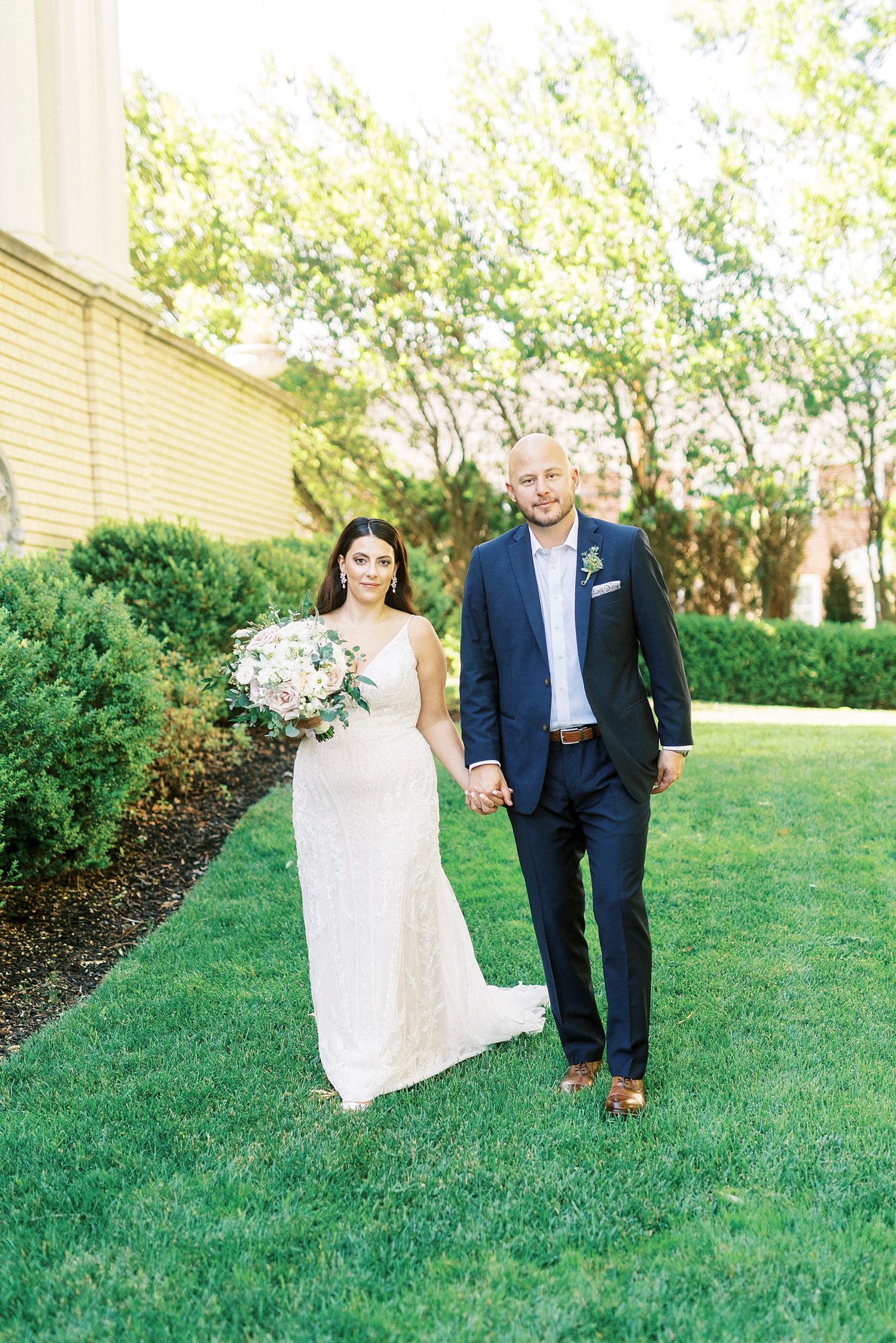 bride and groom walk on lawn at Separk Mansion
