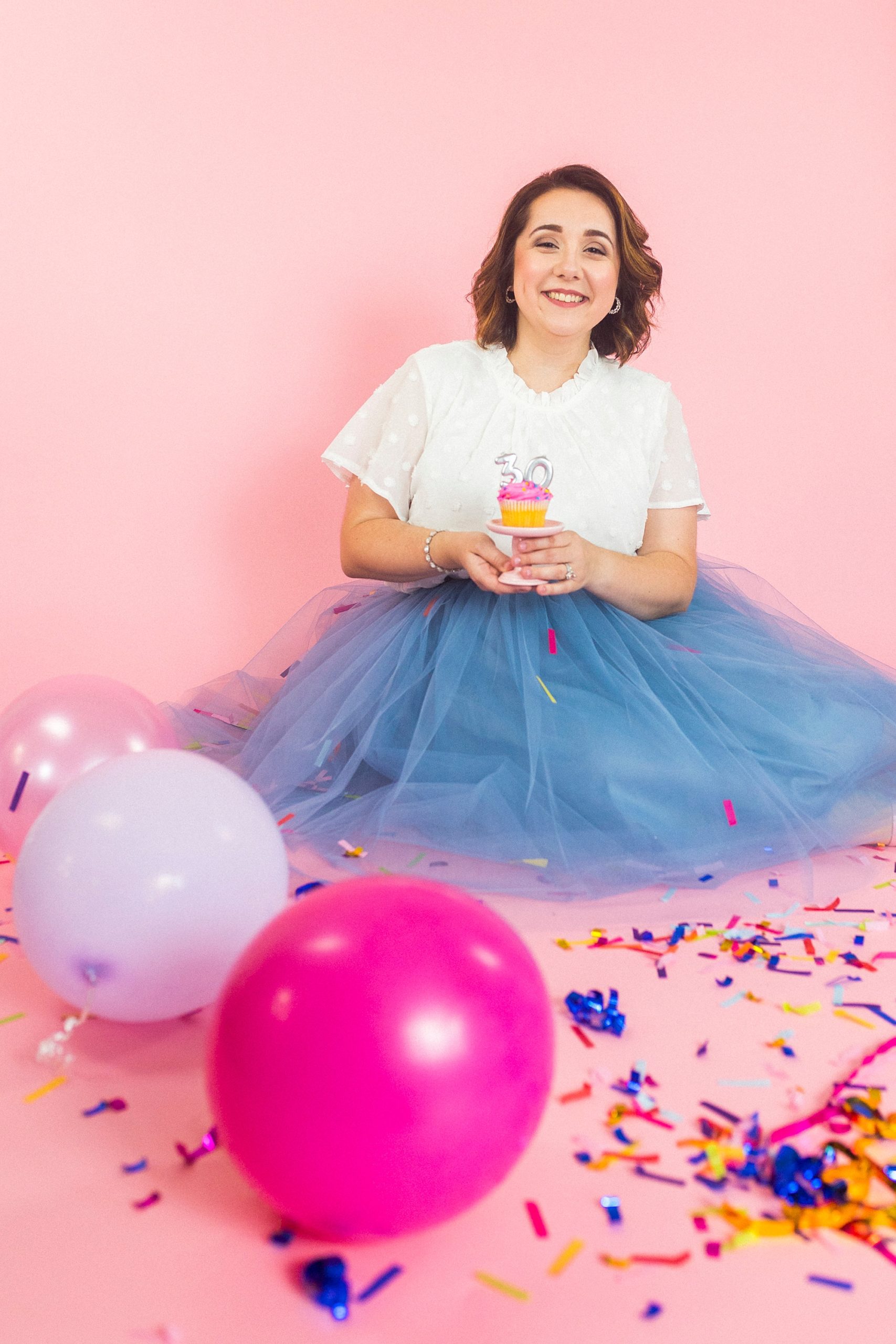 30th birthday portraits for woman with confetti and pink balloons