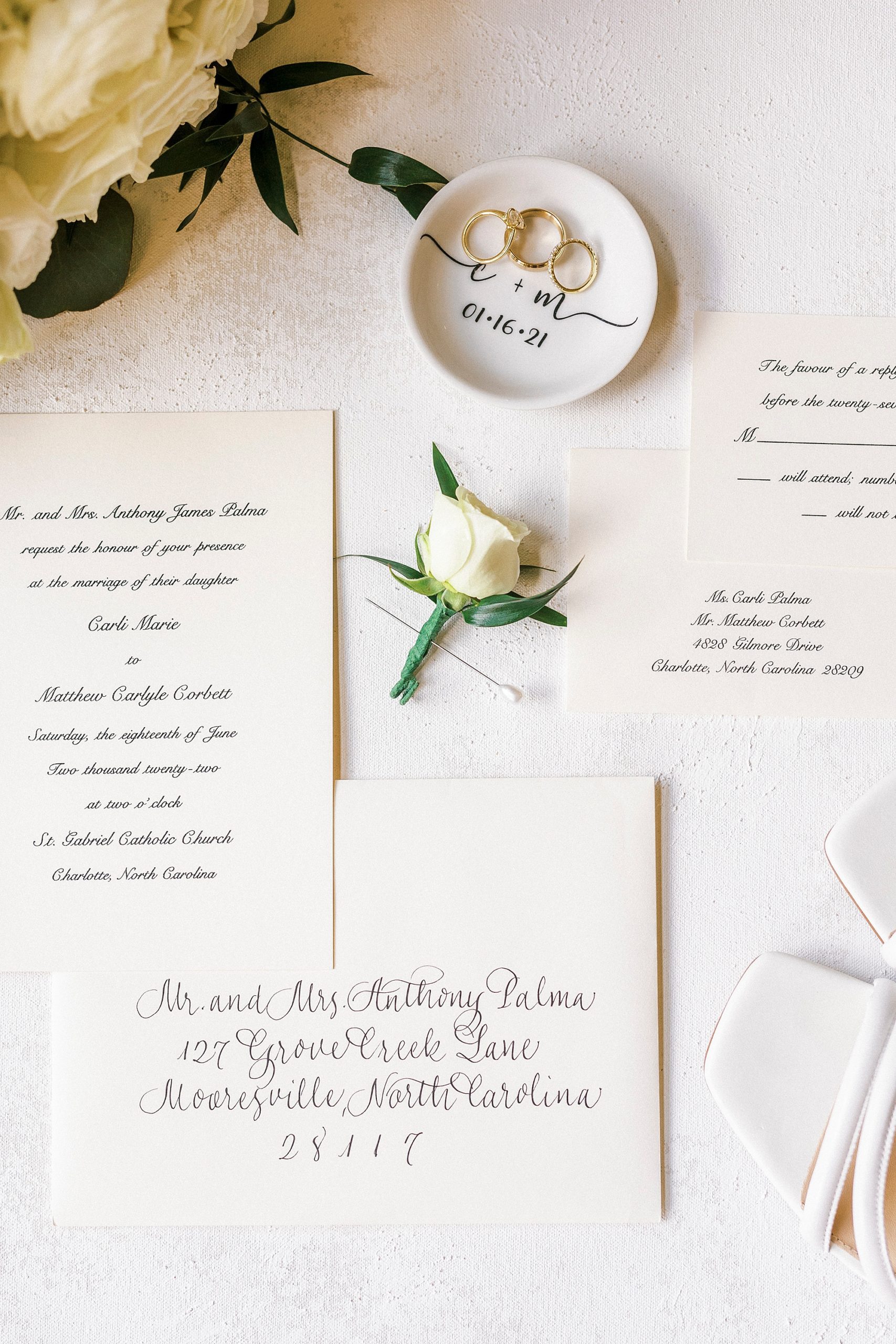 groom's ivory rose boutonnière with stationery