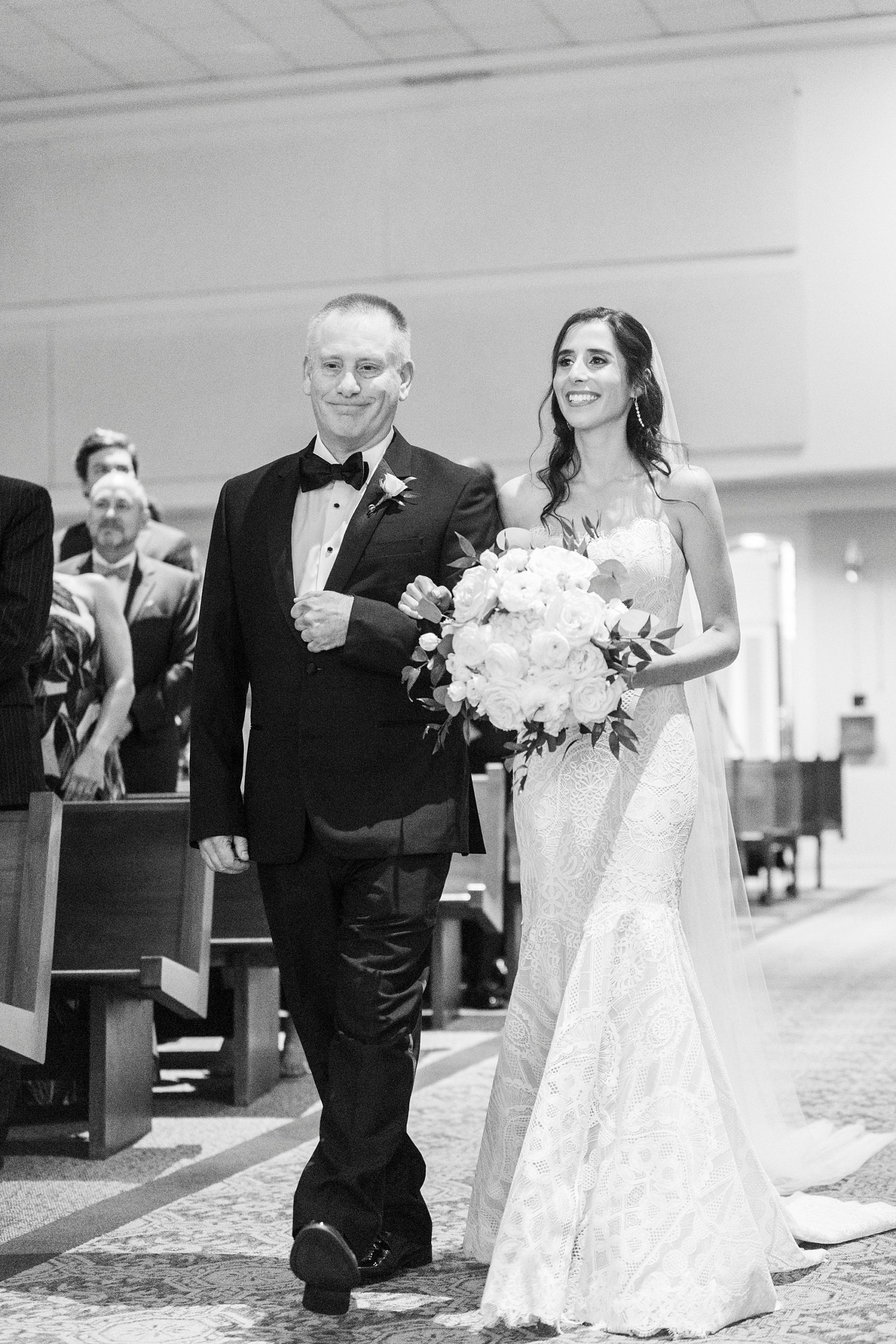 bride walks down aisle with dad at St. Gabriel Catholic Church