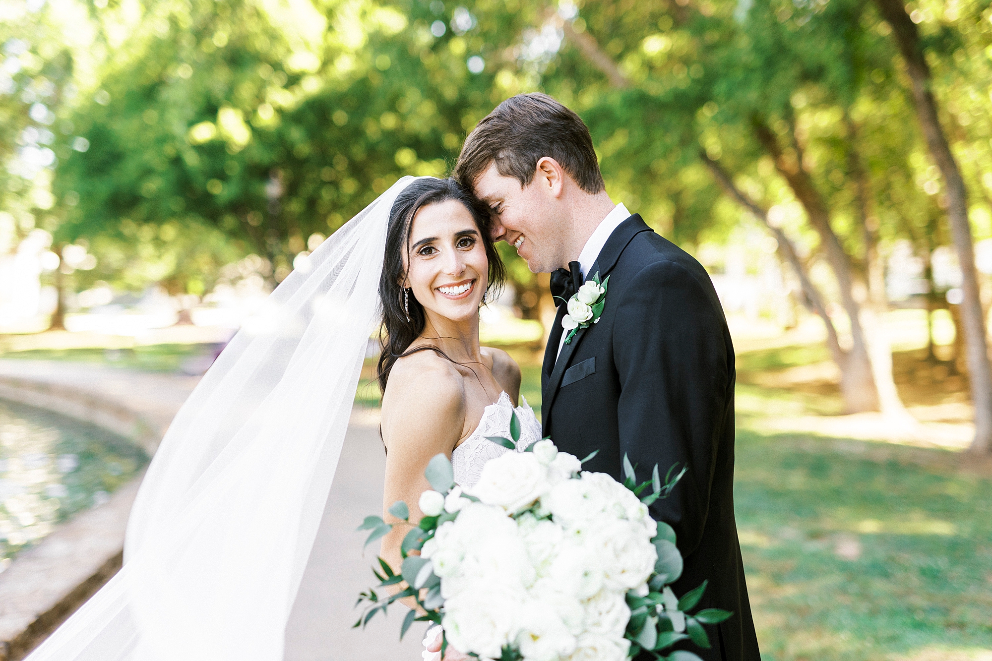 groom leans into bride's forehead during Freedom Park wedding portraits