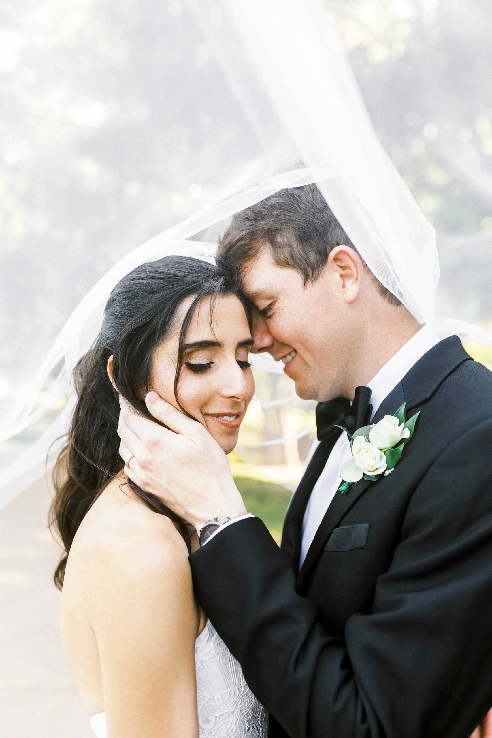 groom nuzzles bride's forehead under veil at Freedom Park