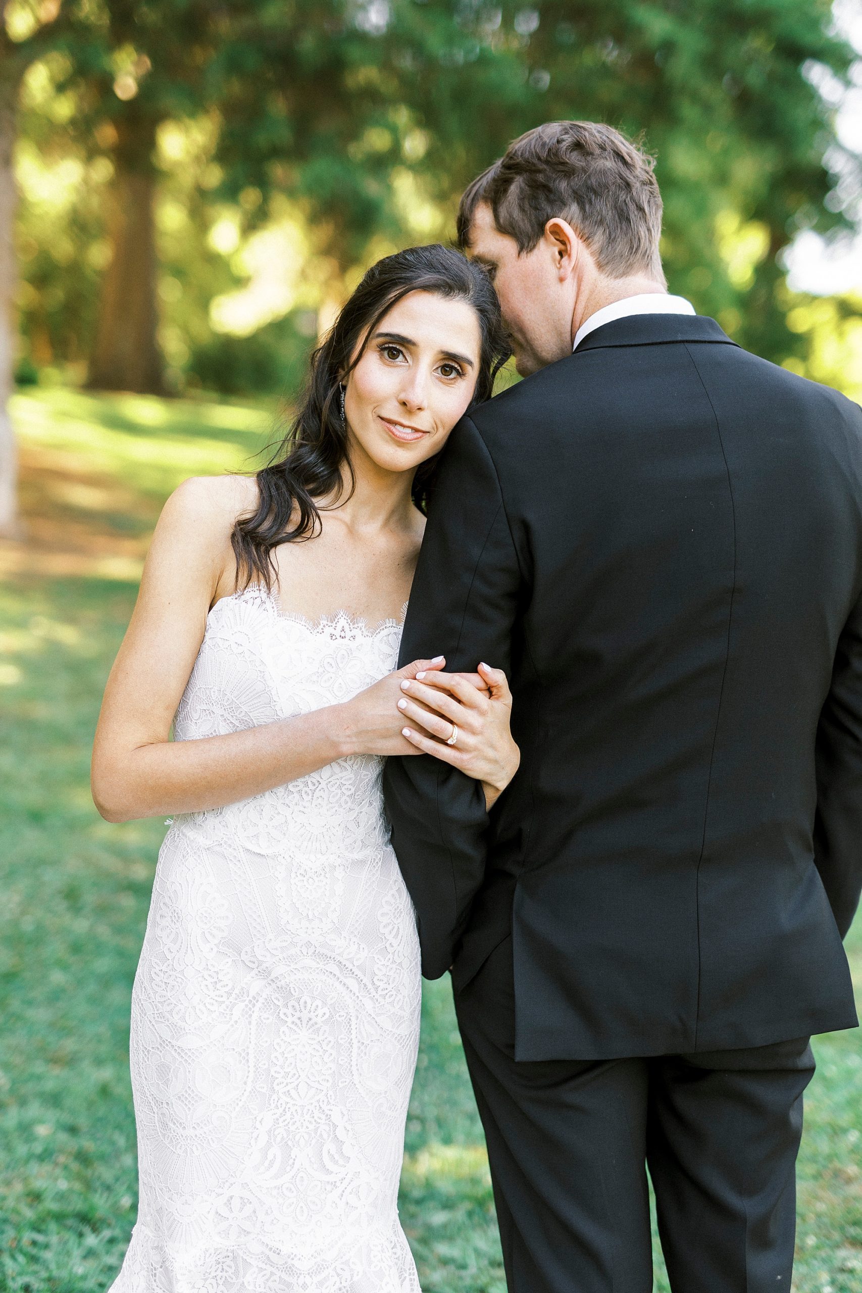 bride leans on groom's shoulder in Freedom Park
