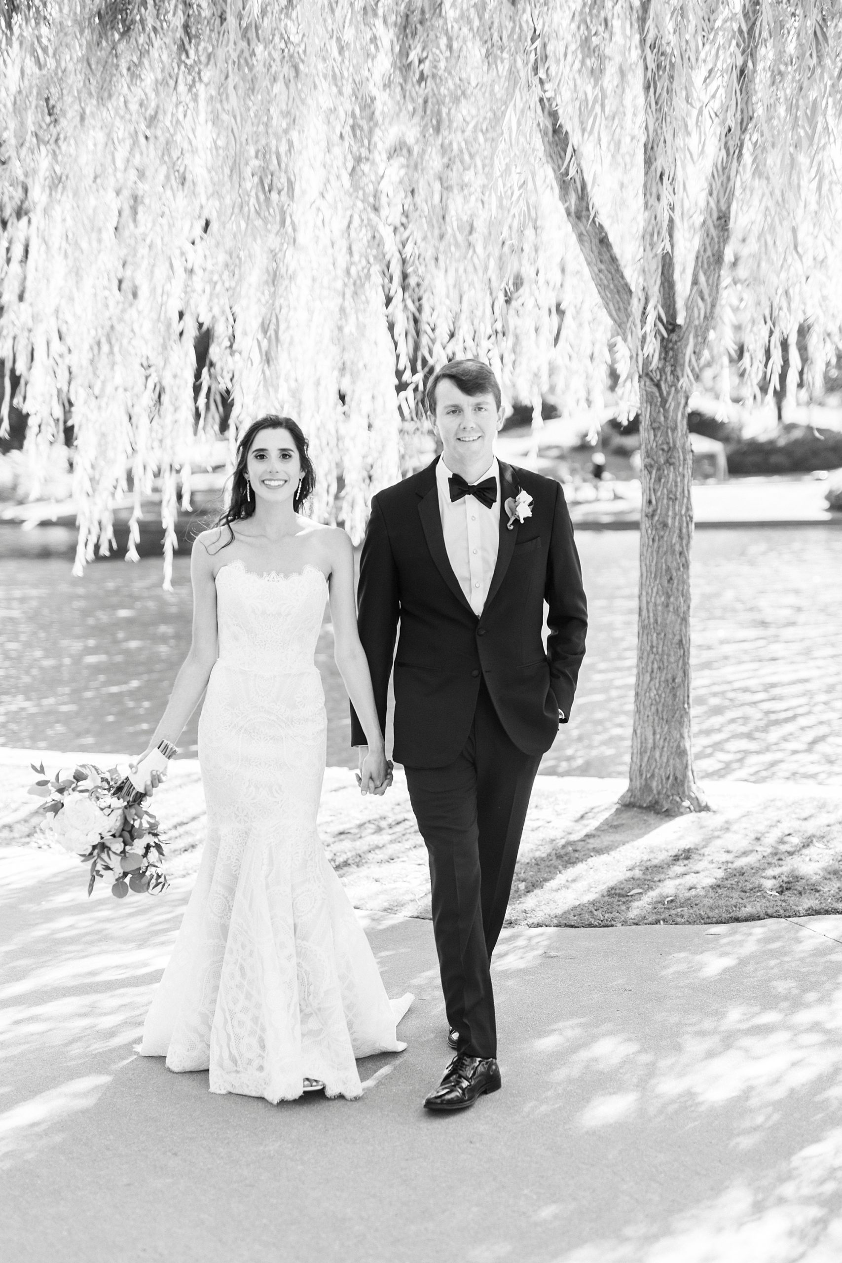 bride and groom hold hands walking through Freedom Park in Charlotte NC