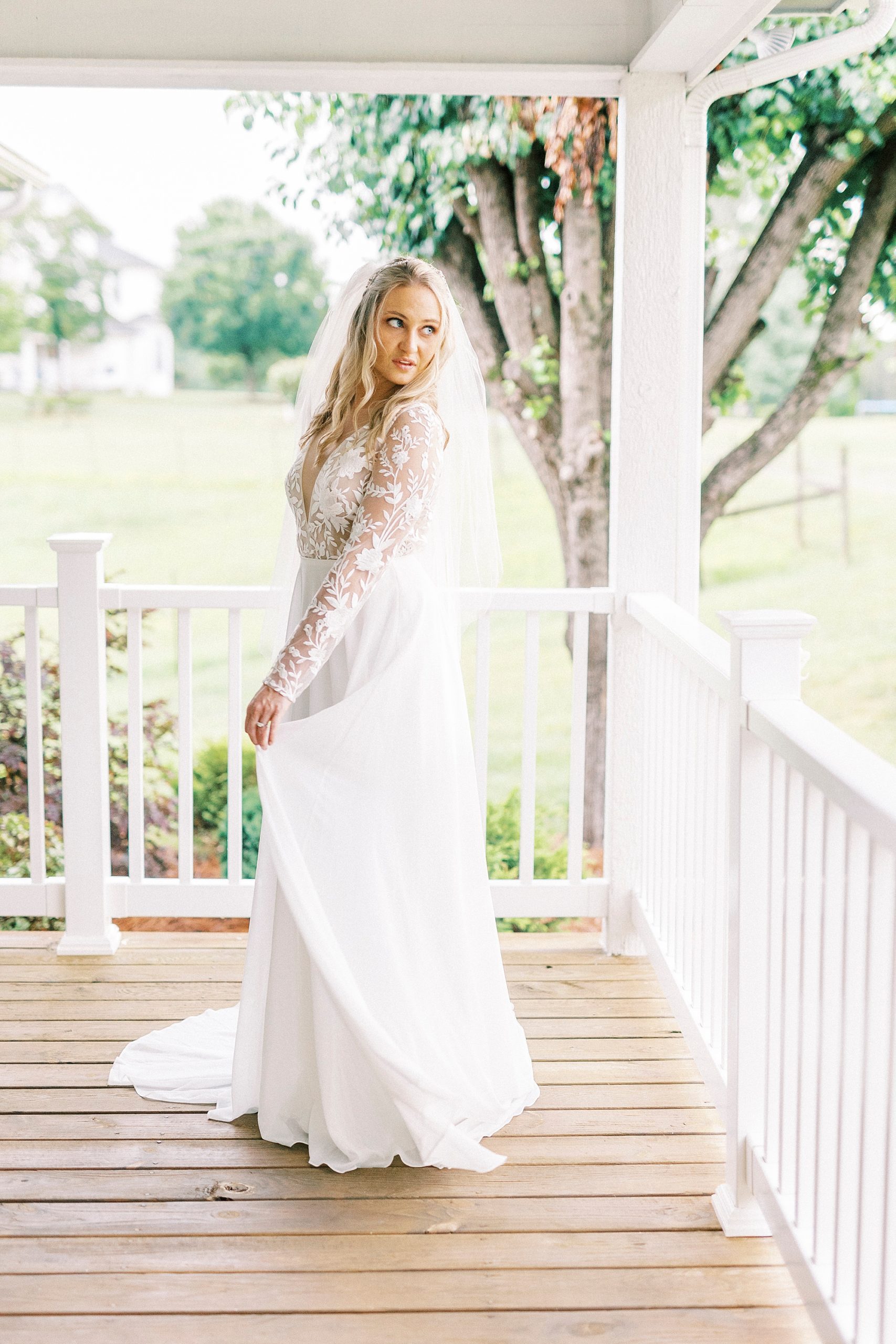 bride looks over shoulder in wedding gown