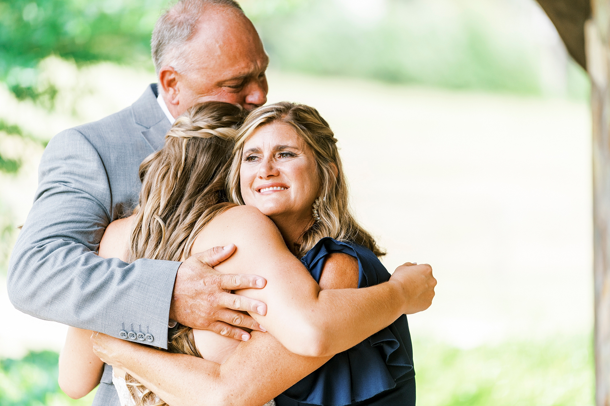 bride hugs parents before NC wedding day