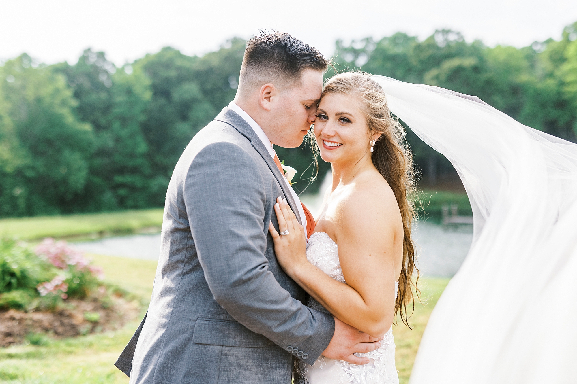 groom nuzzles bride's cheek during NC wedding portraits 