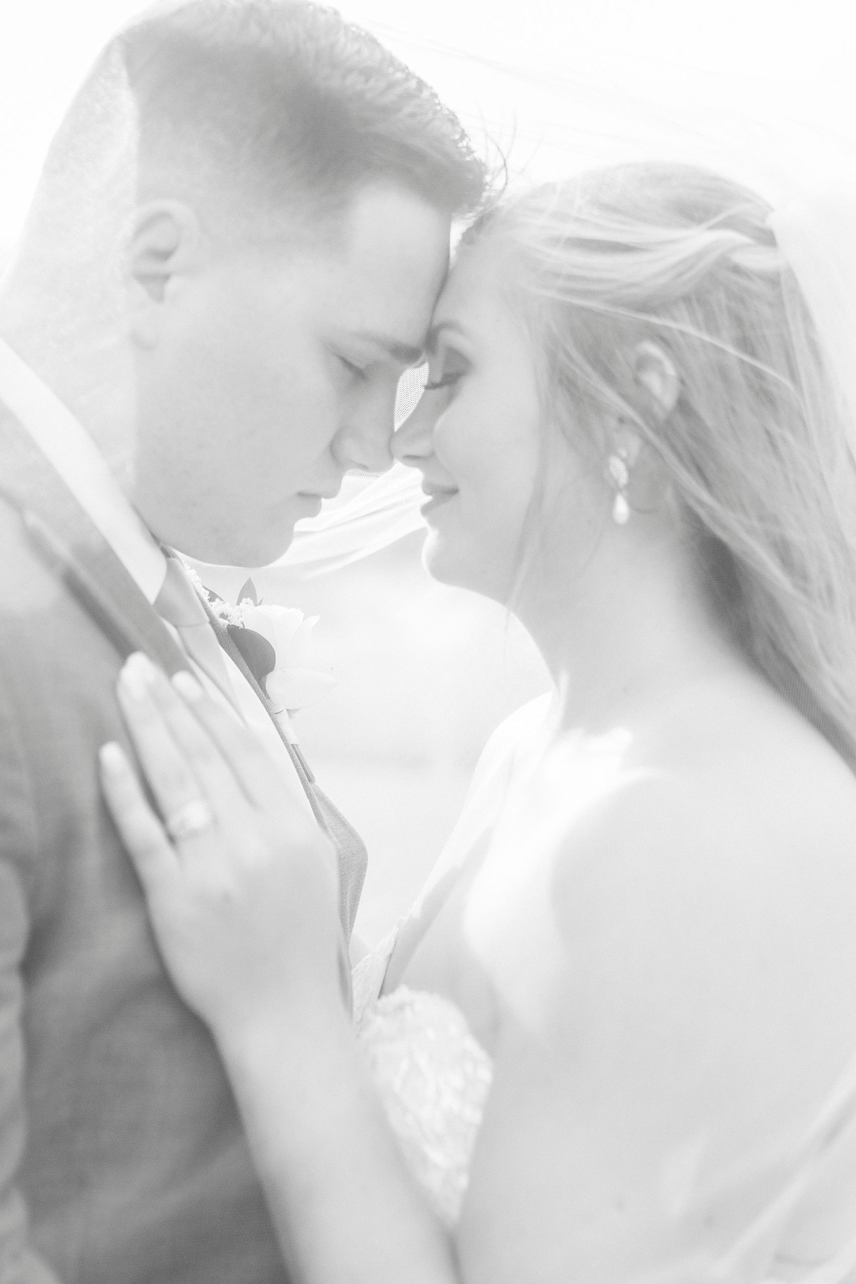 bride and groom lean noses together during portraits at The Stable at Riverview