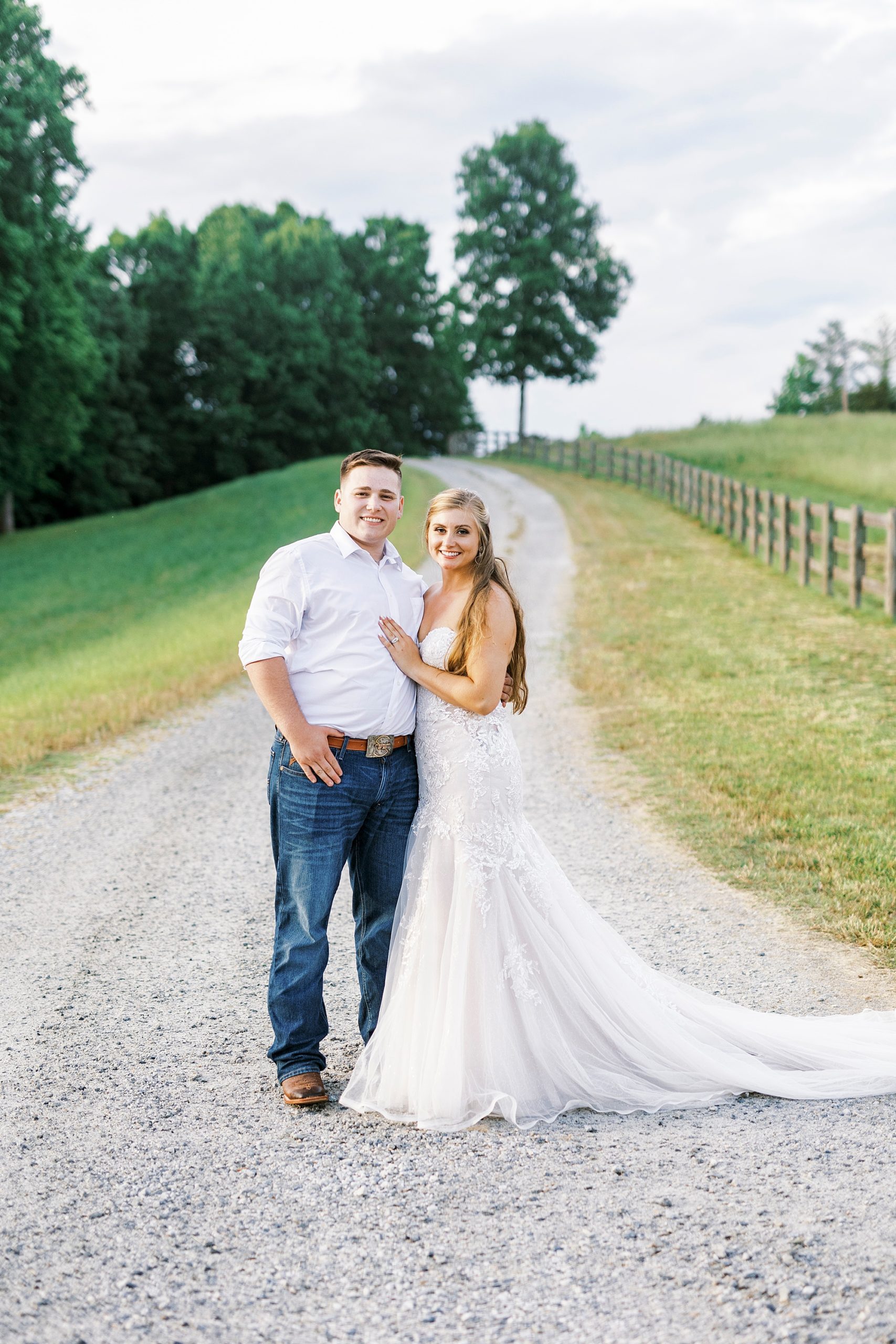 bride and groom stand together on pathway at The Stable at Riverview