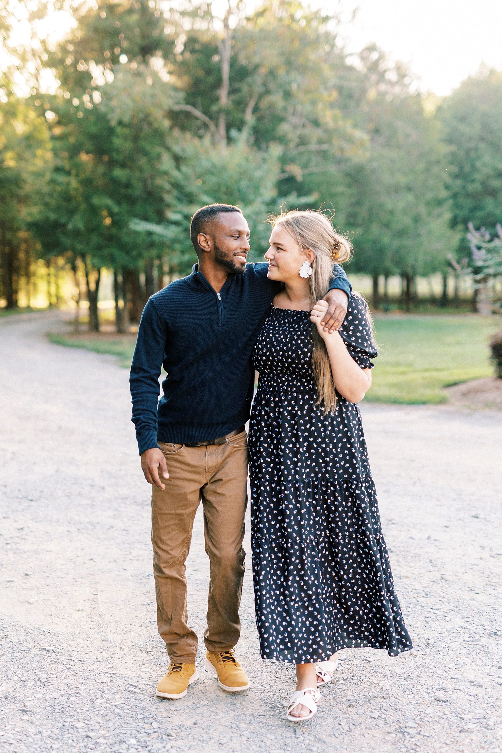 couple walks down path with arms around each other at Bella Terra