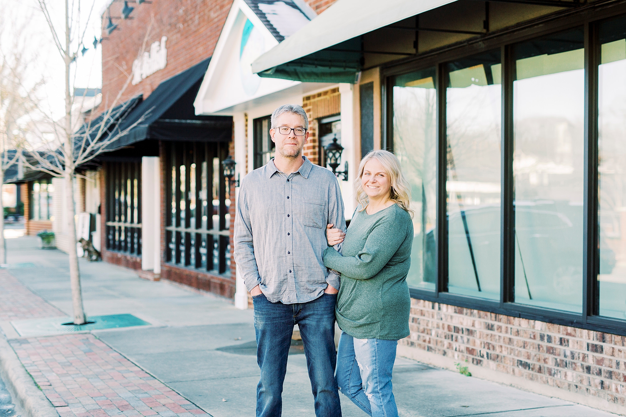 couple poses on street in Downtown Monroe