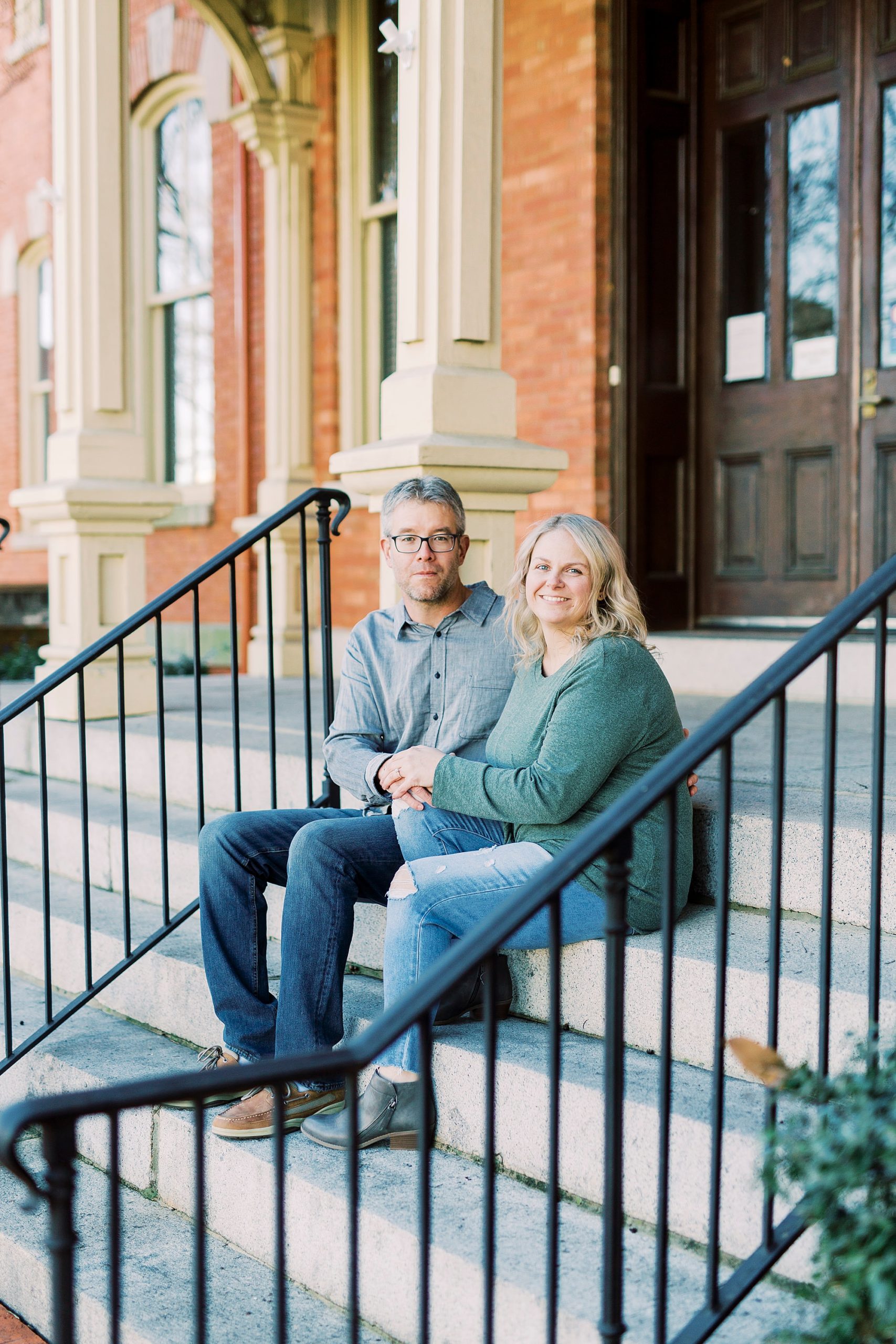 engaged couple sits on steps in Monroe NC