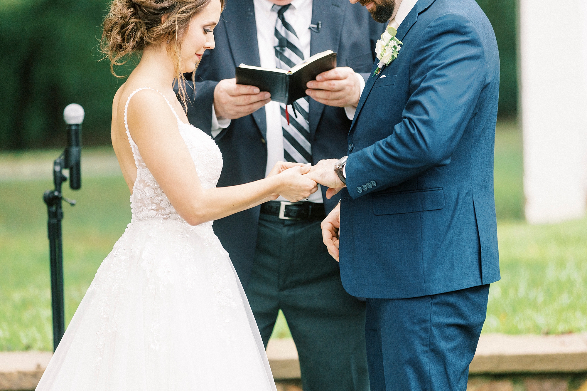 couple holds hands during ceremony at Boxwood Estate