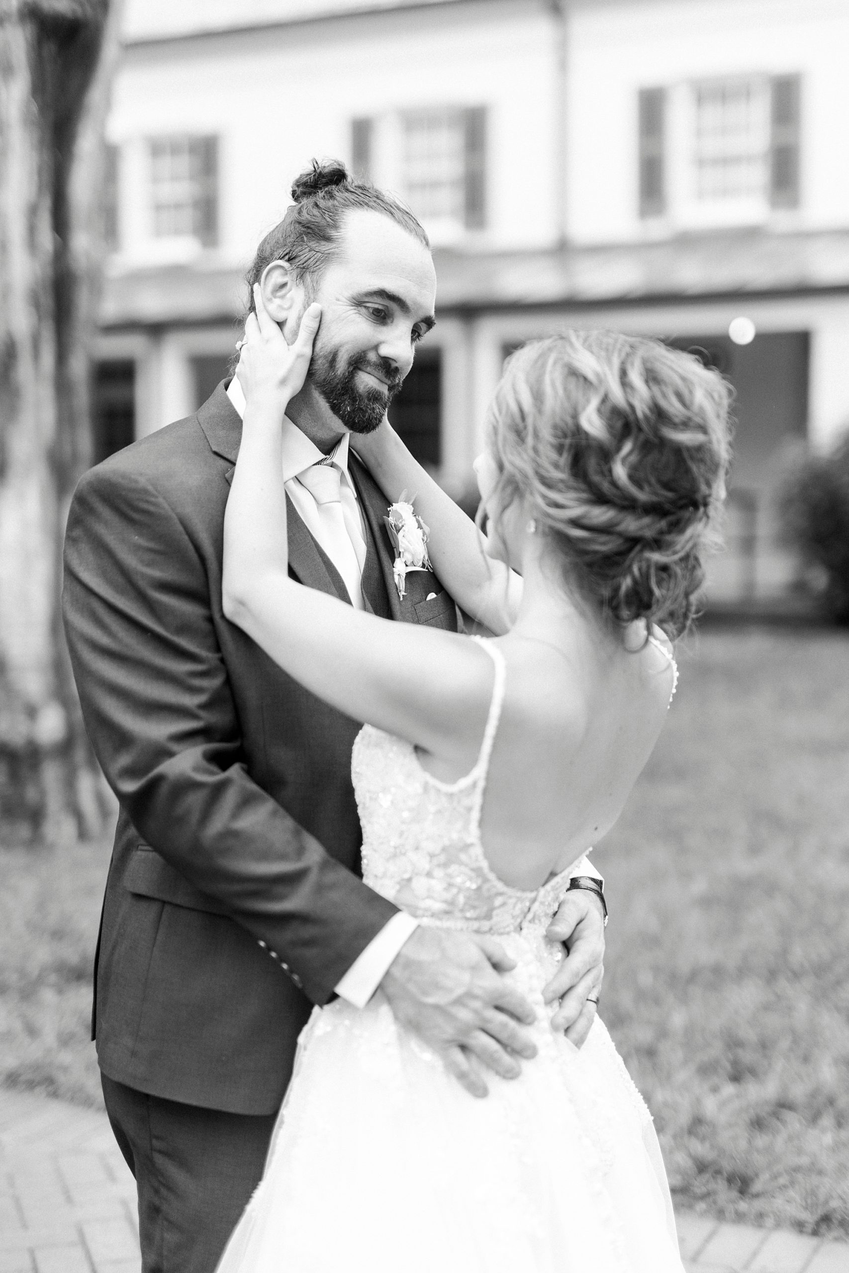 bride smiles up at groom hugging him