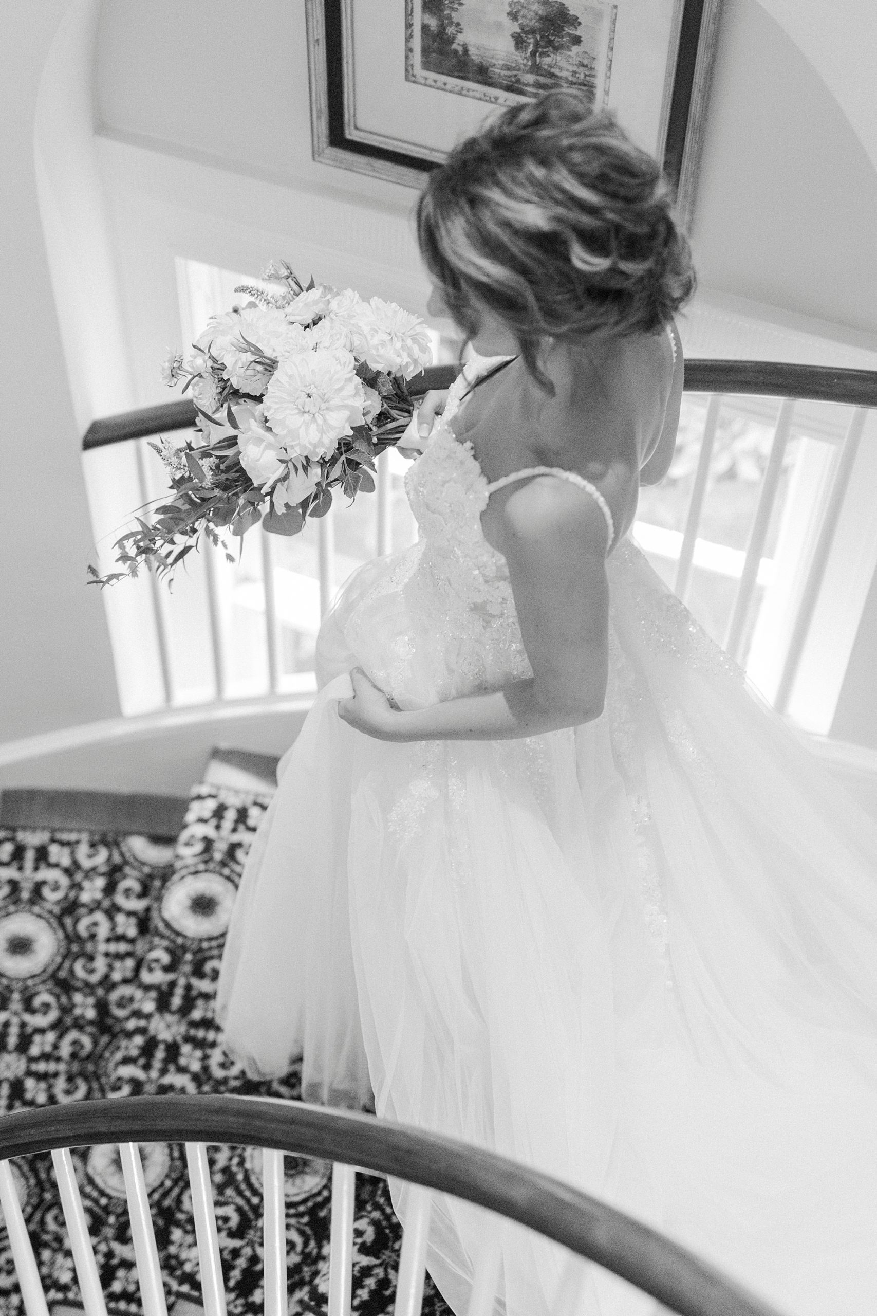 bride walks down steps at Boxwood Estate