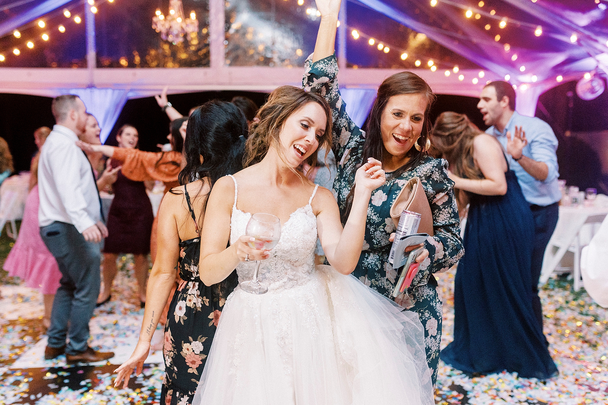 bride dances with guest during NC reception