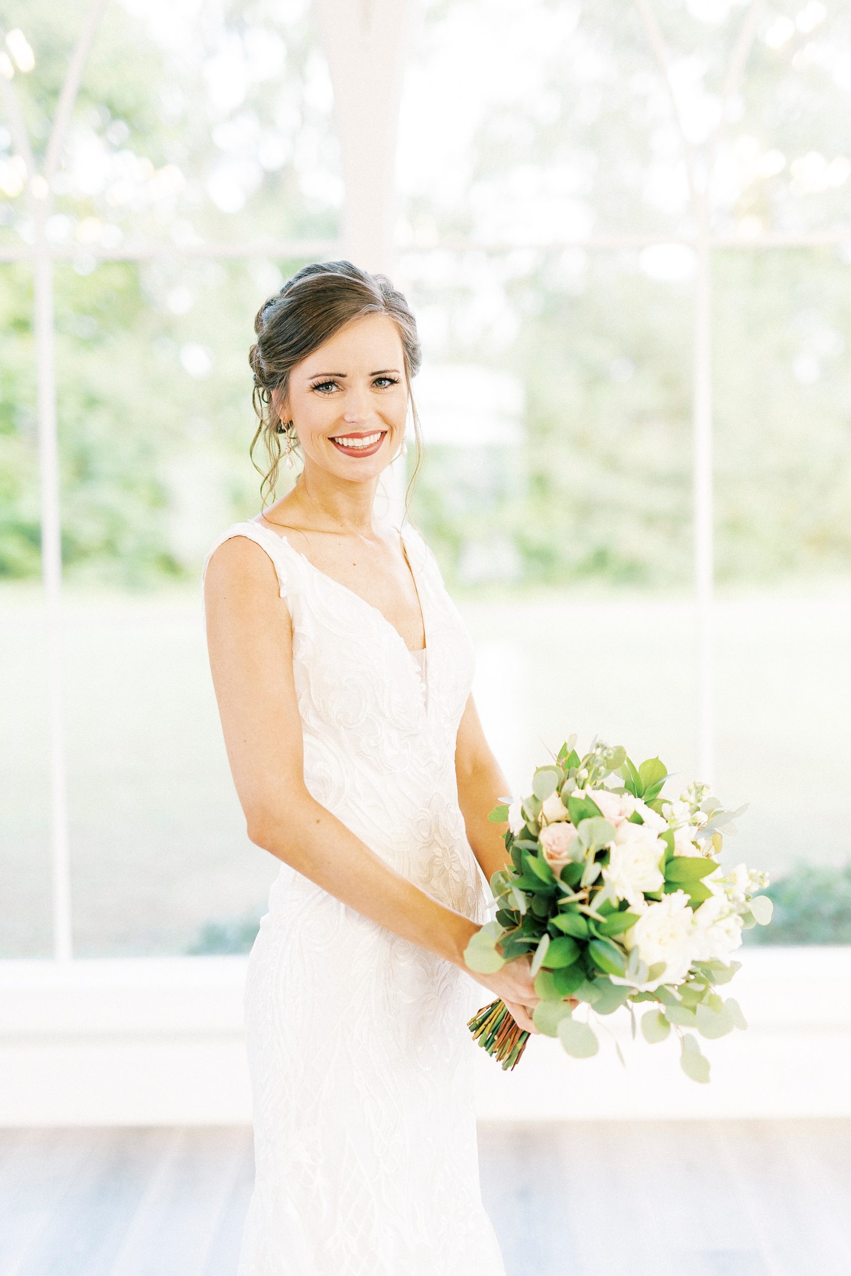 bride stands with v-neck wedding gown in chapel at Chickadee Hill Farms