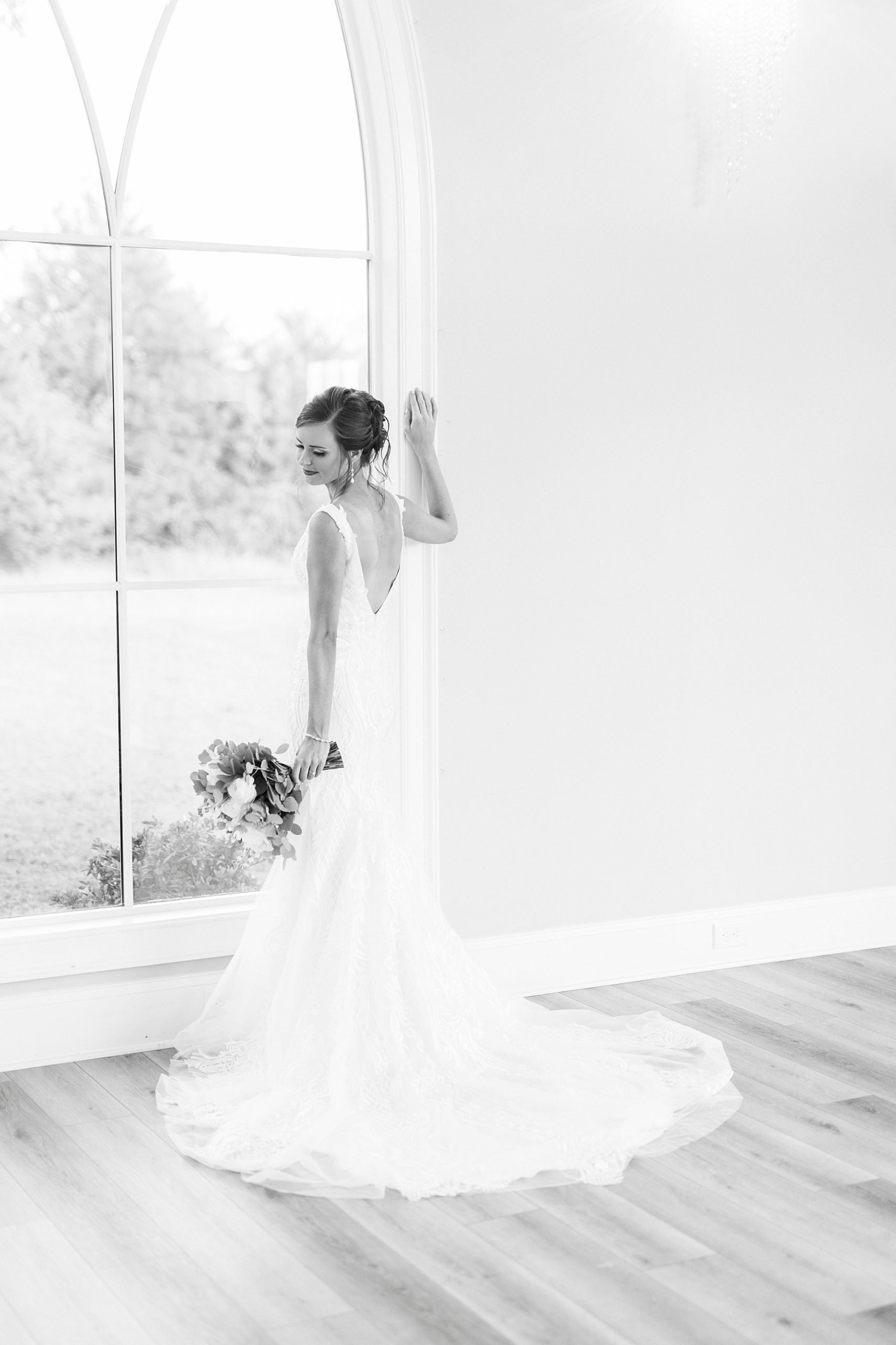 black and white portrait of bride in window at Chickadee Hill Farms