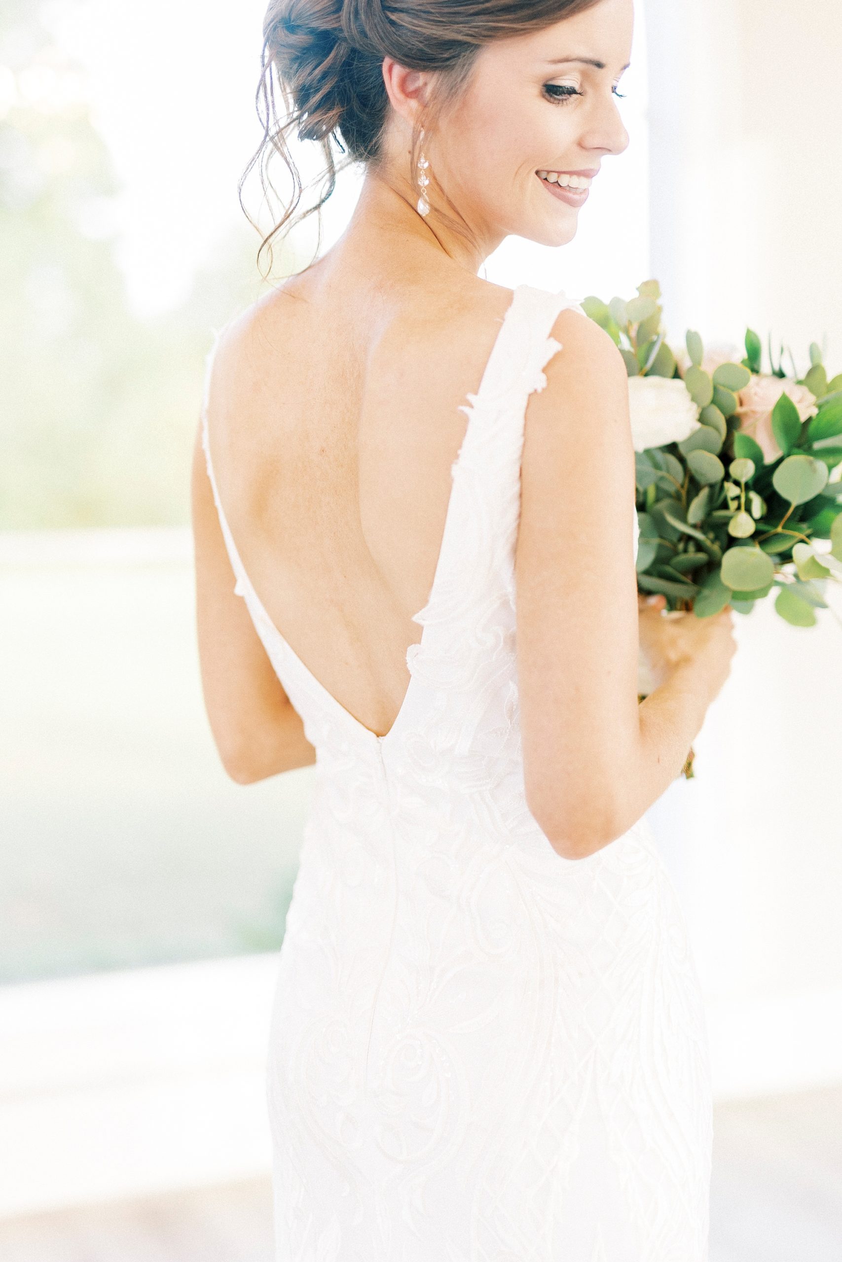 bride looks over shoulder laughing at Chickadee Hill Farms