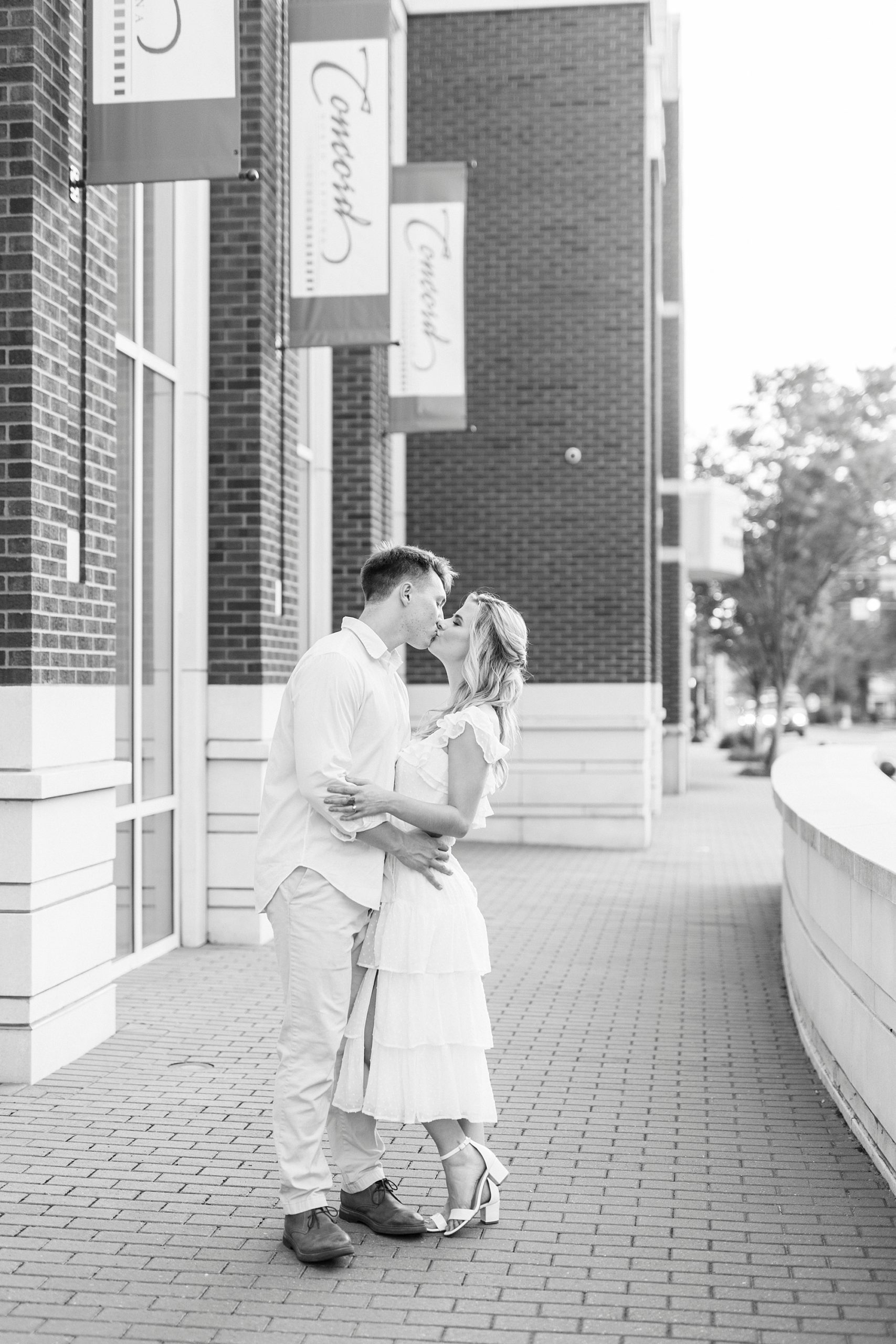 engaged couple kisses outside Concord NC police station