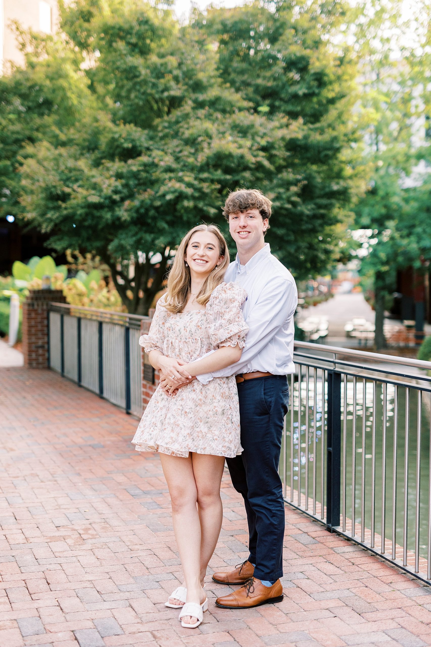 man hugs fiancee during American Tobacco Campus engagement session
