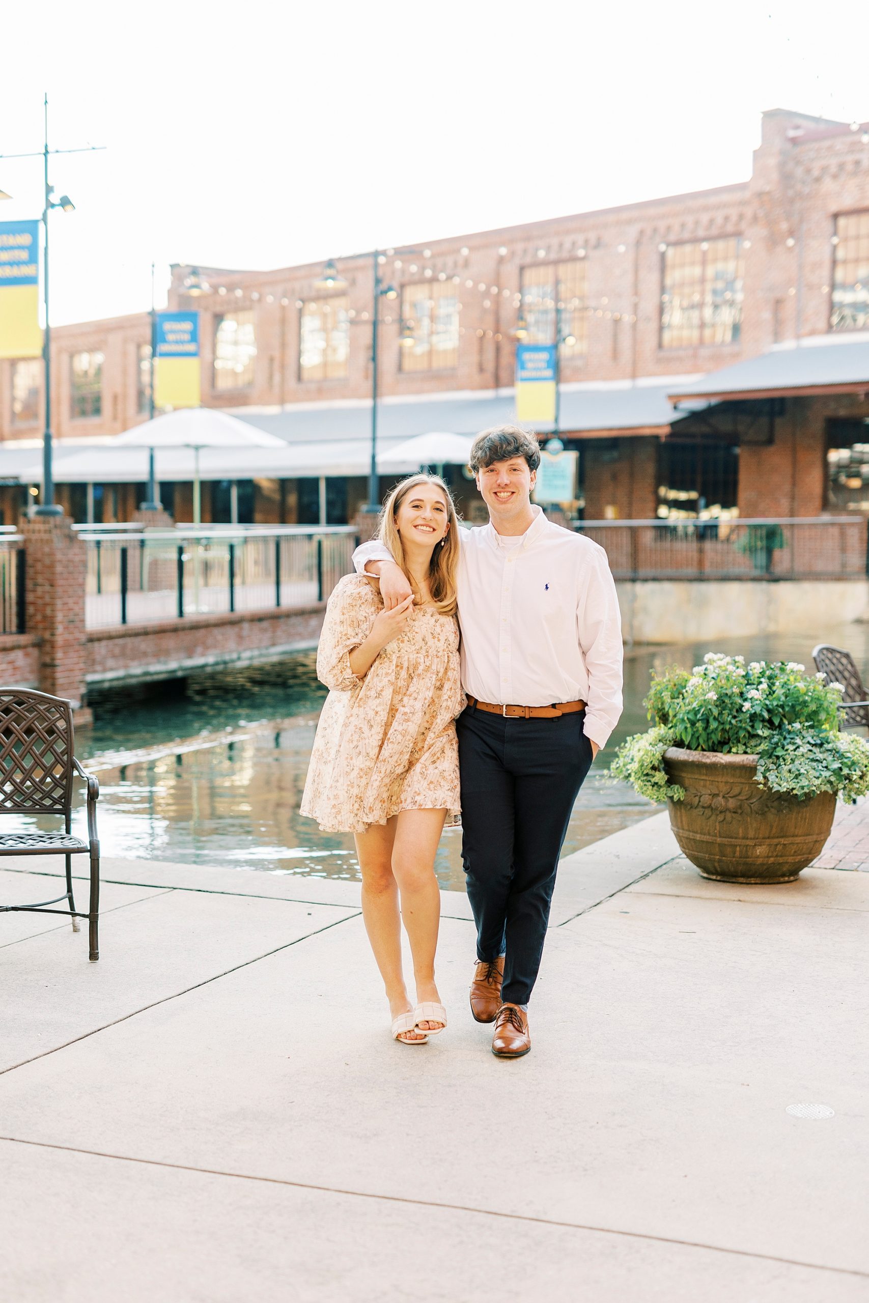 couple hugs walking along water in Durham NC