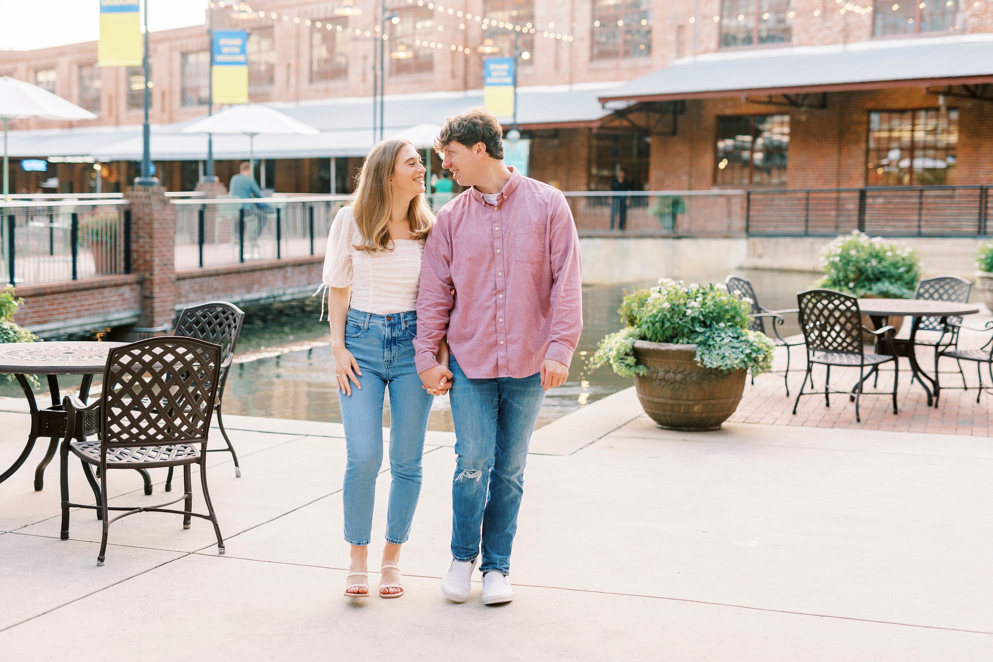 couple holds hands walking in Durham NC