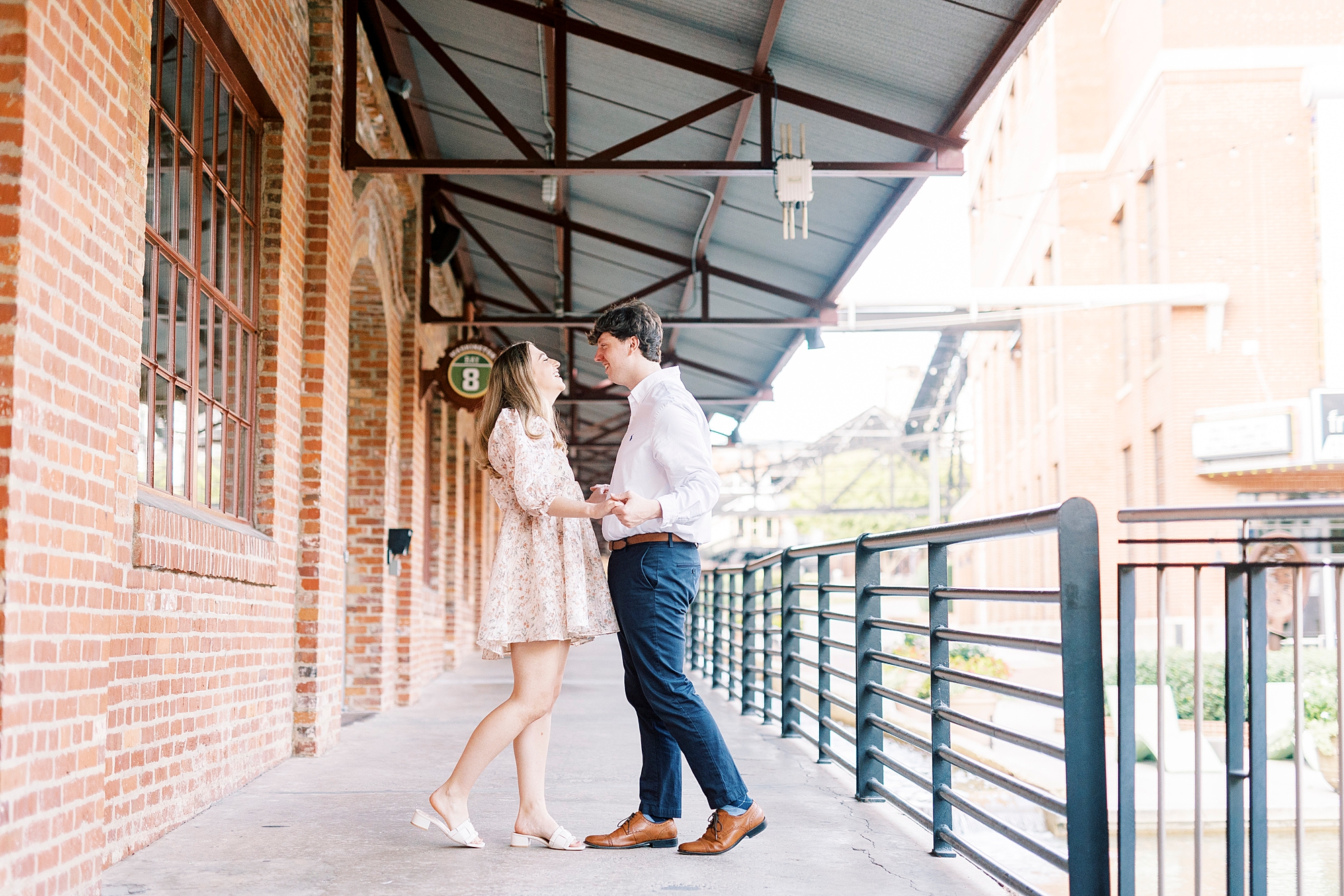 NC couple hugs on balcony at the American Tobacco Campus