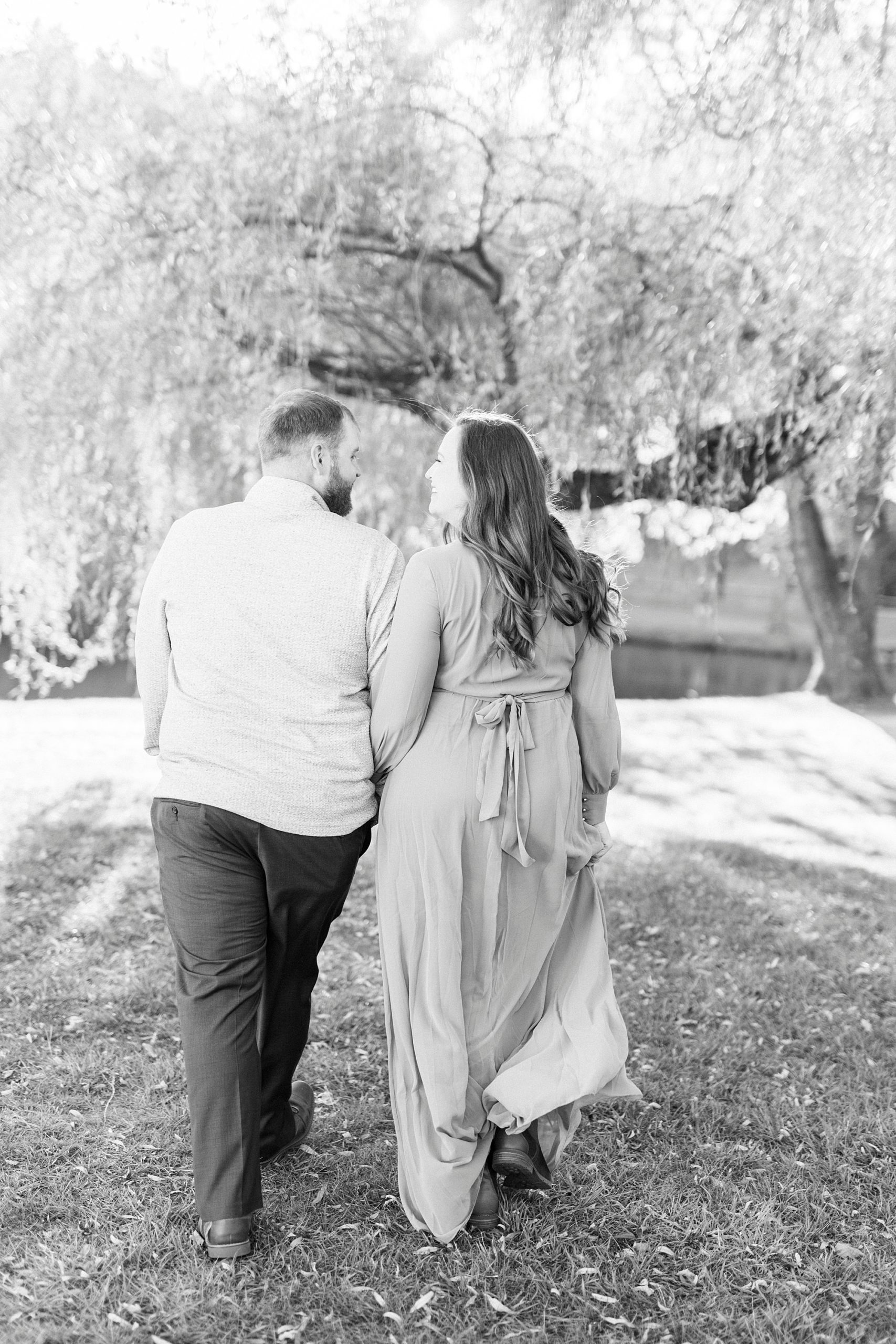 bride and groom hold hands walking through lawn at Chetola Resort