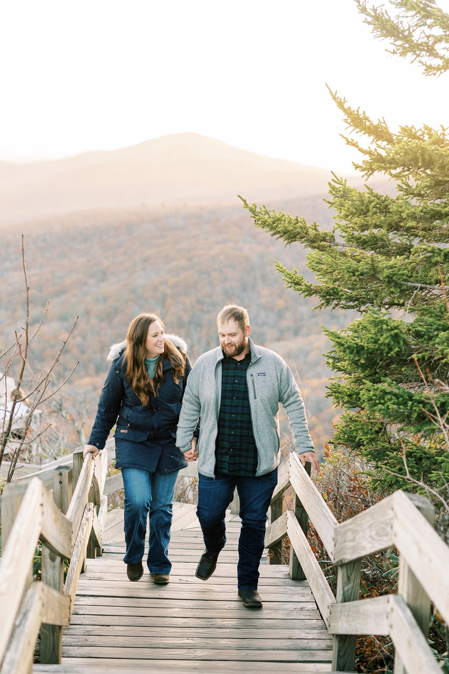engaged couple walks up steps on Blue Ridge Parkway