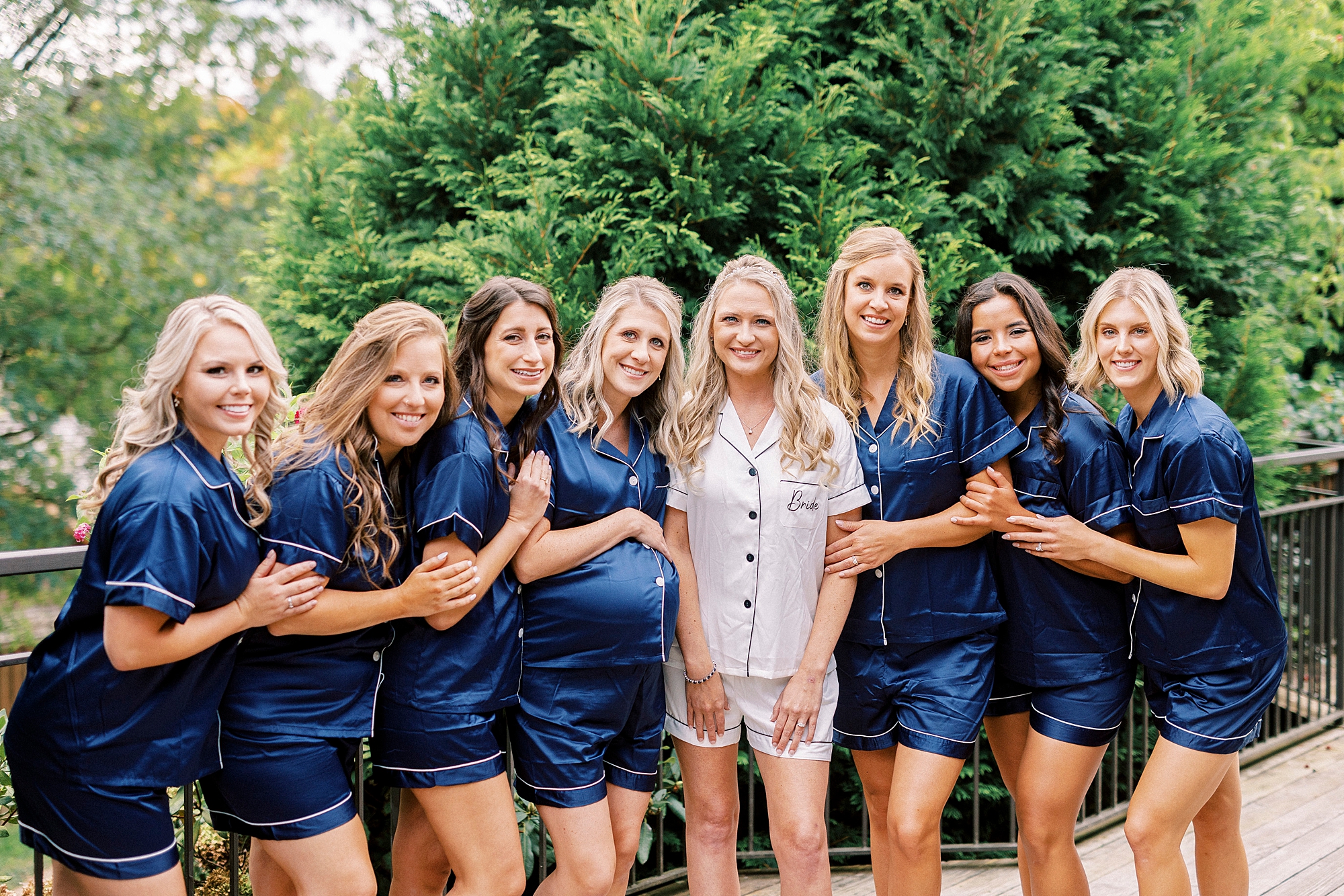 bride and bridesmaids pose in navy pajamas