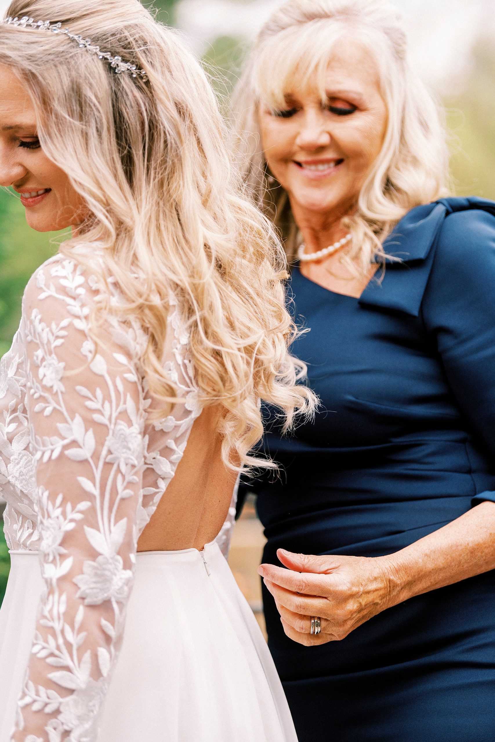 mother helps bride with wedding gown before Chetola Resort wedding