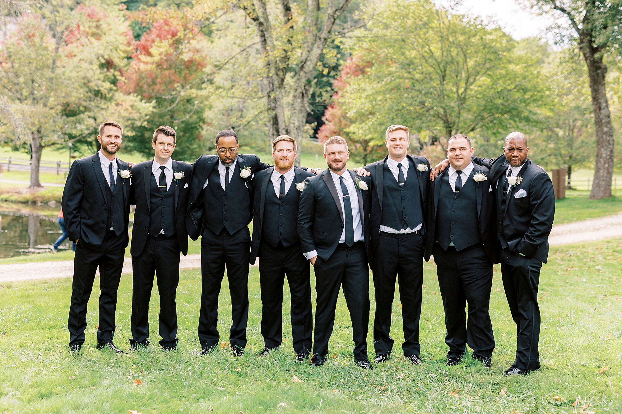 groom and groomsmen pose on lawn at Chetola Resort