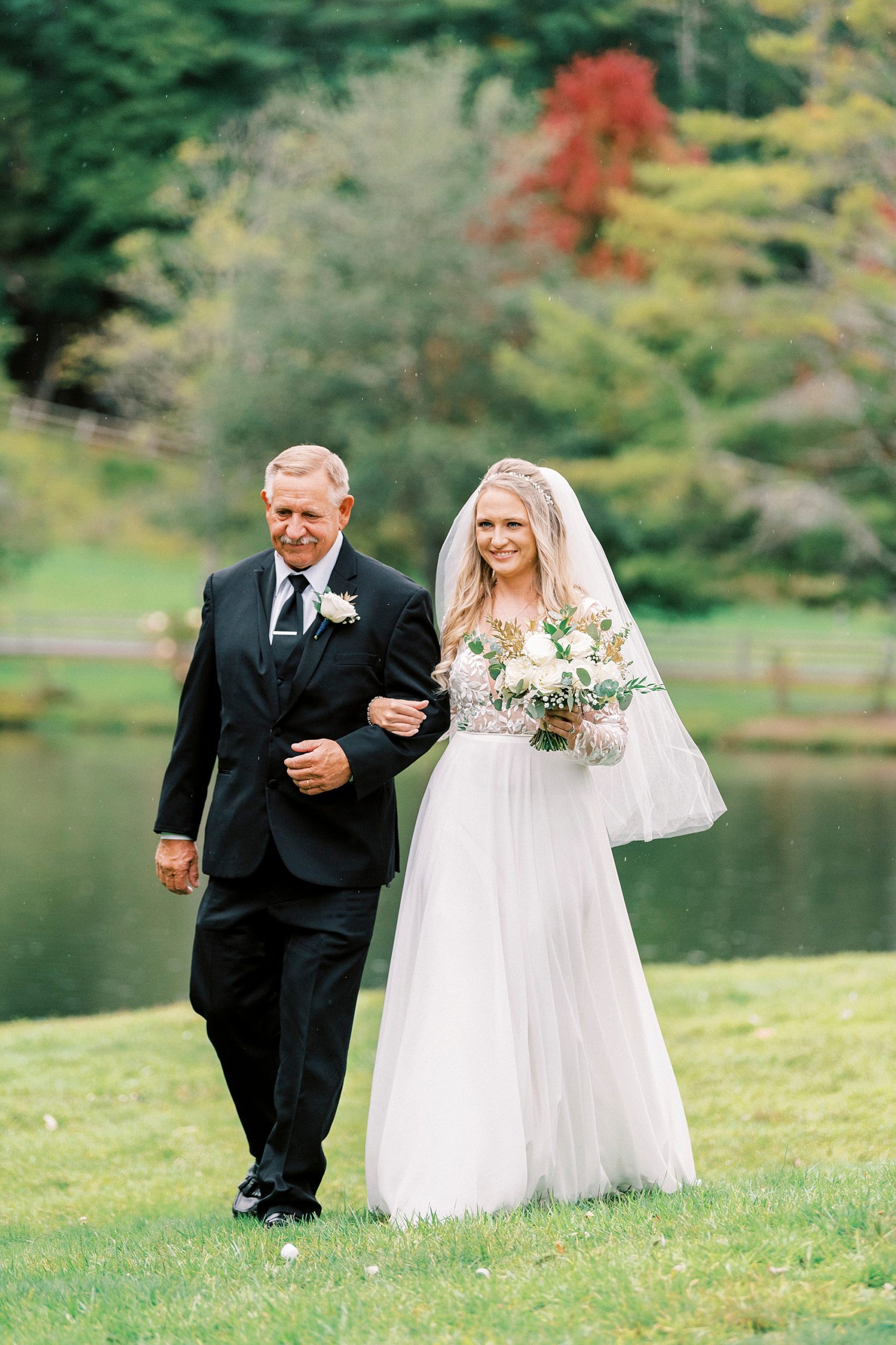 bride walks down aisle with dad at Chetola Resort