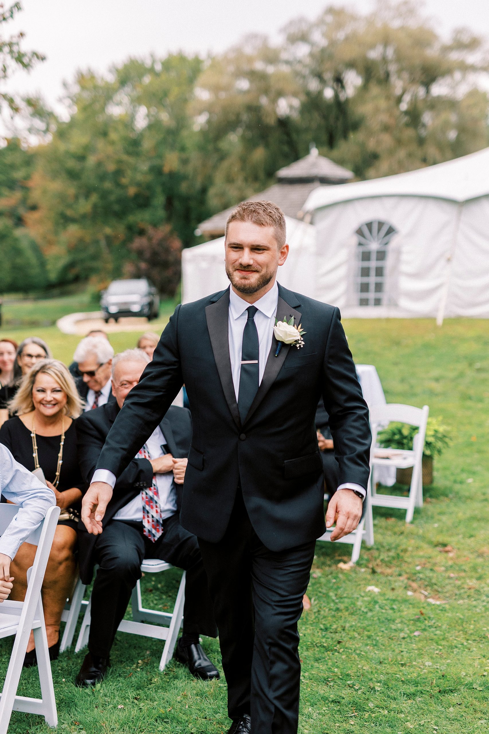 groom walks down aisle for outdoor ceremony at Chetola Resort