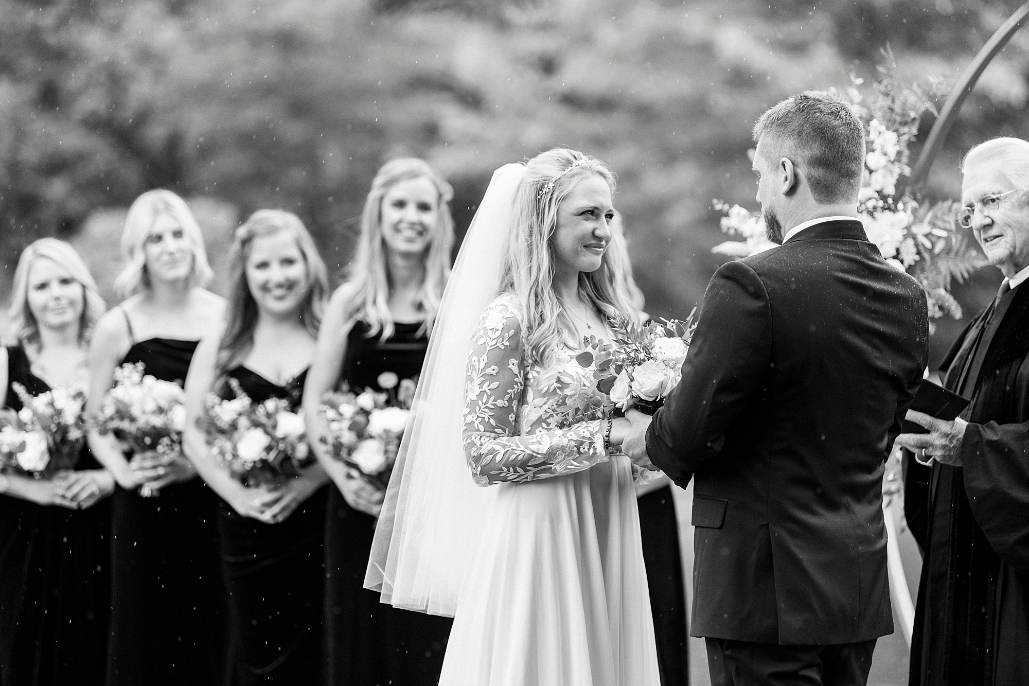 bride smiles at groom during wedding ceremony at Chetola Resort