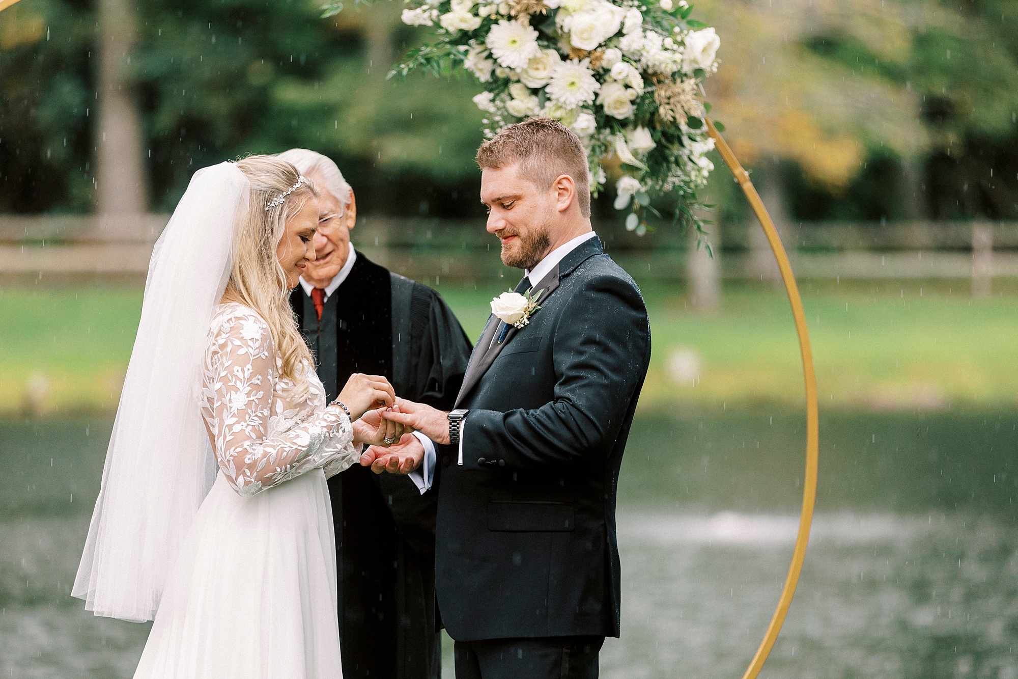 bride puts ring on groom during wedding ceremony at Chetola Resort