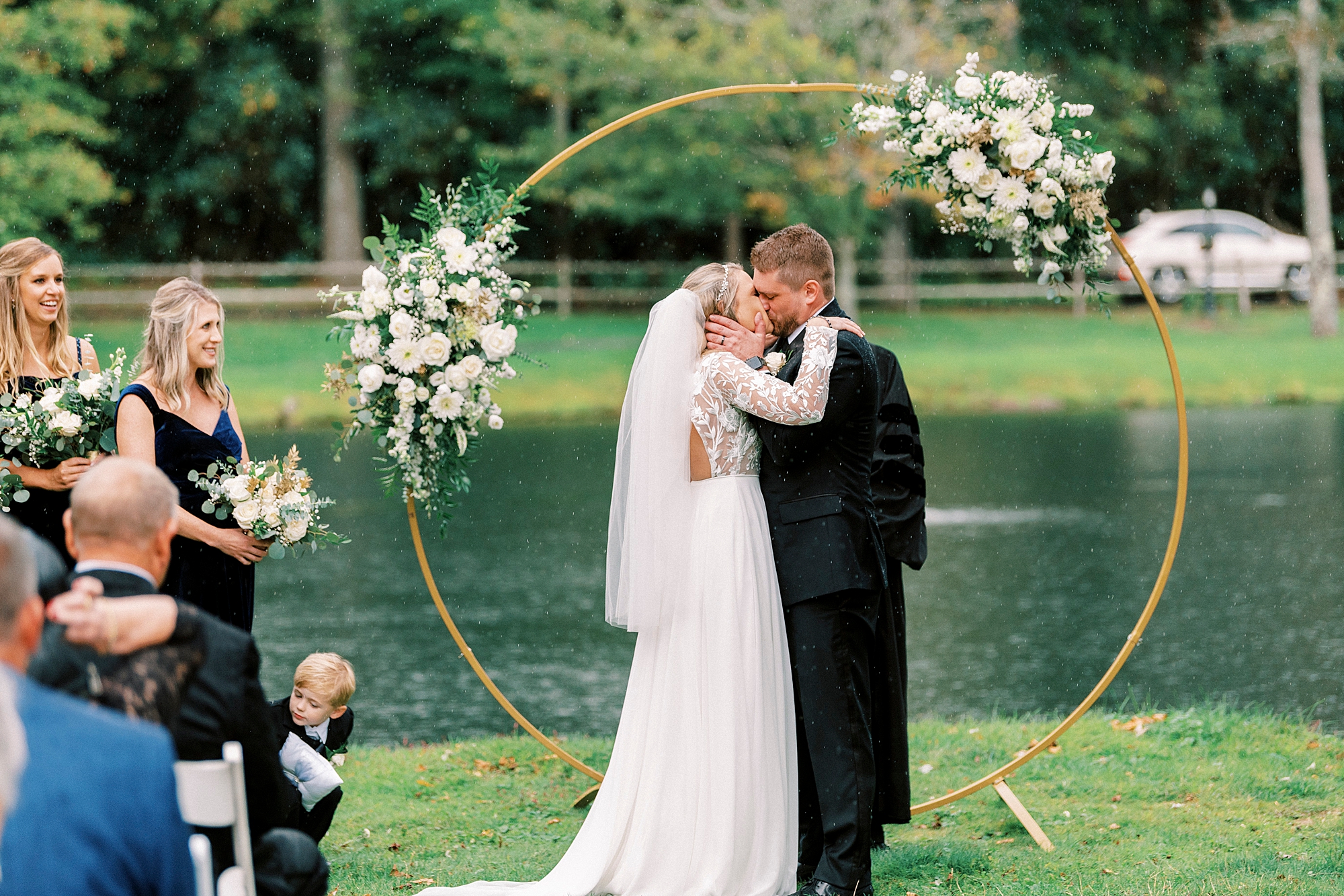 bride and groom kiss by golden circle arbor at Chetola Resort