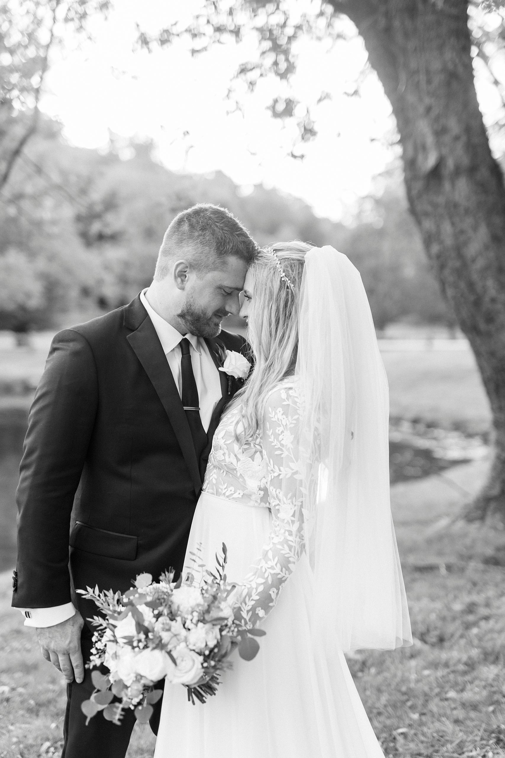 bride and groom smile with foreheads touching at Chetola Resort