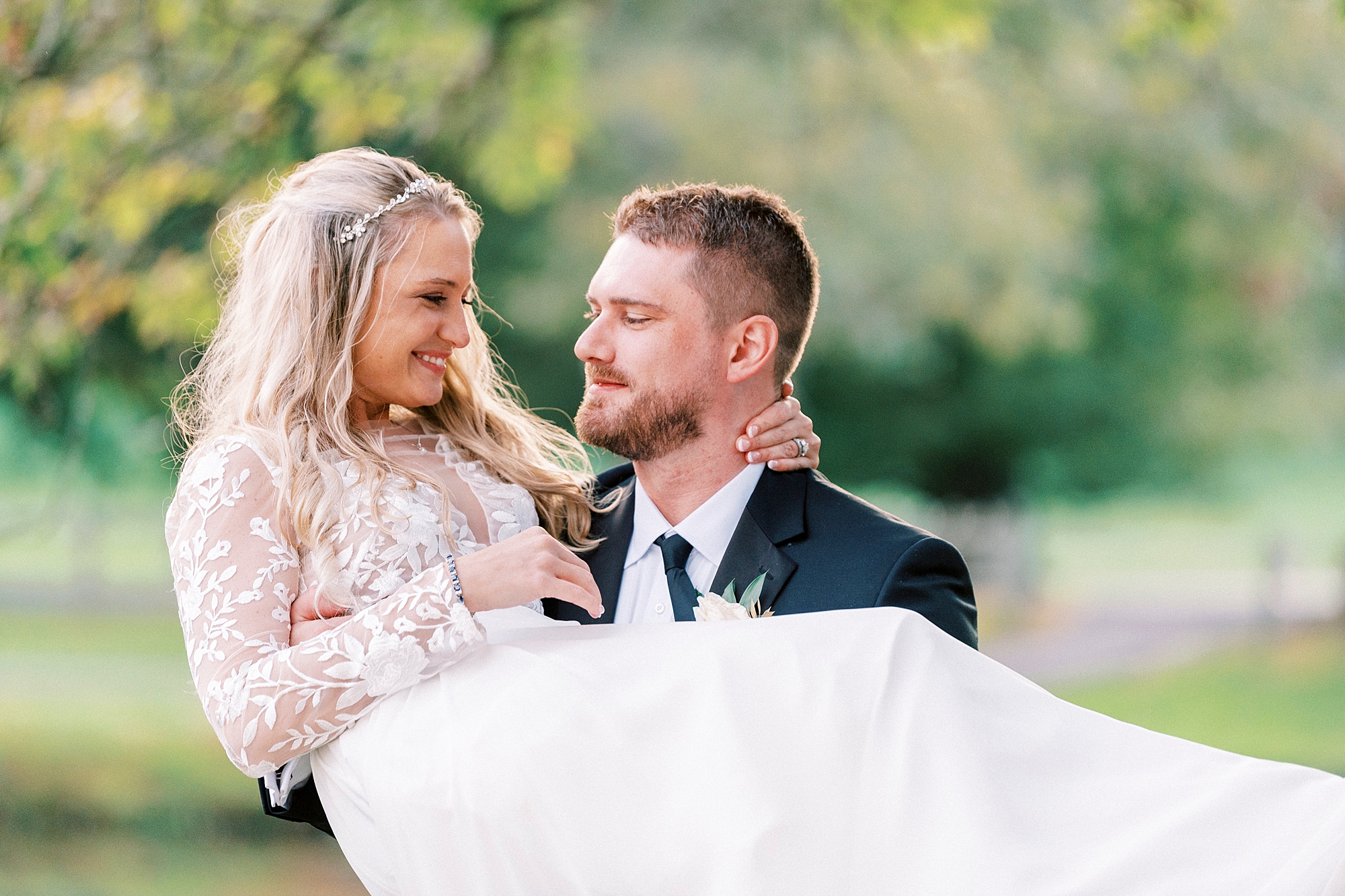 groom carries bride bridal style at Chetola Resort