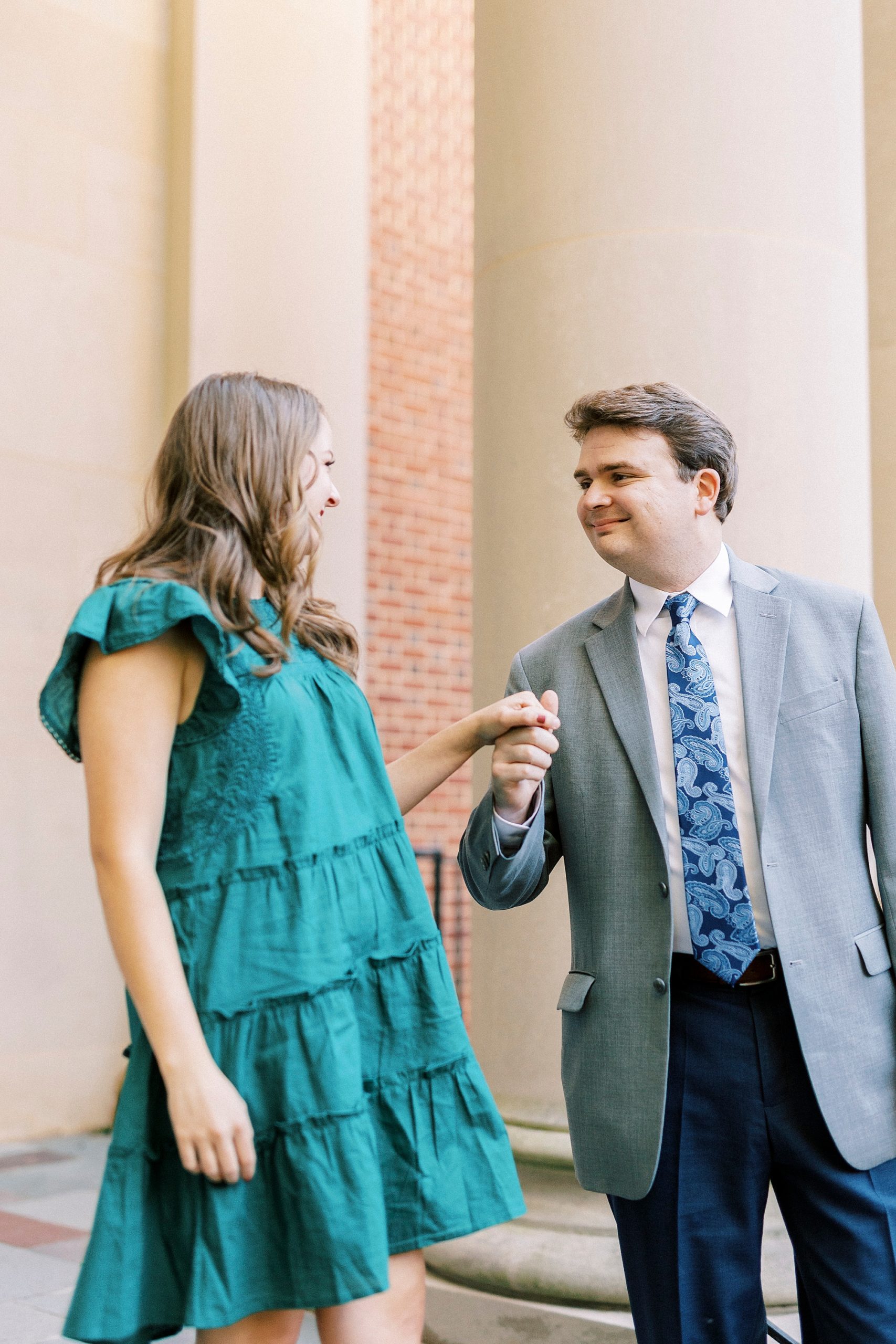 bride and groom hold hands walking down steps