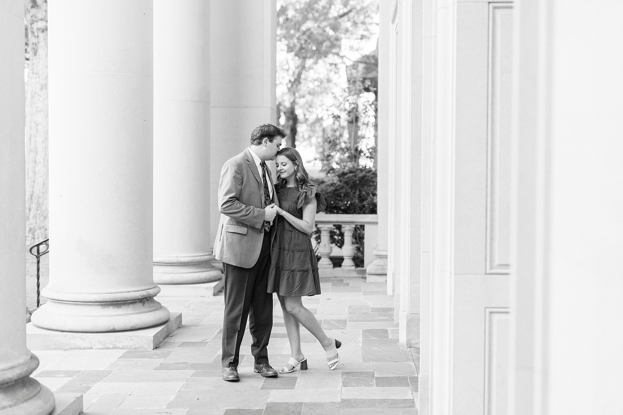 bride and groom hug among arches in Downtown Davidson