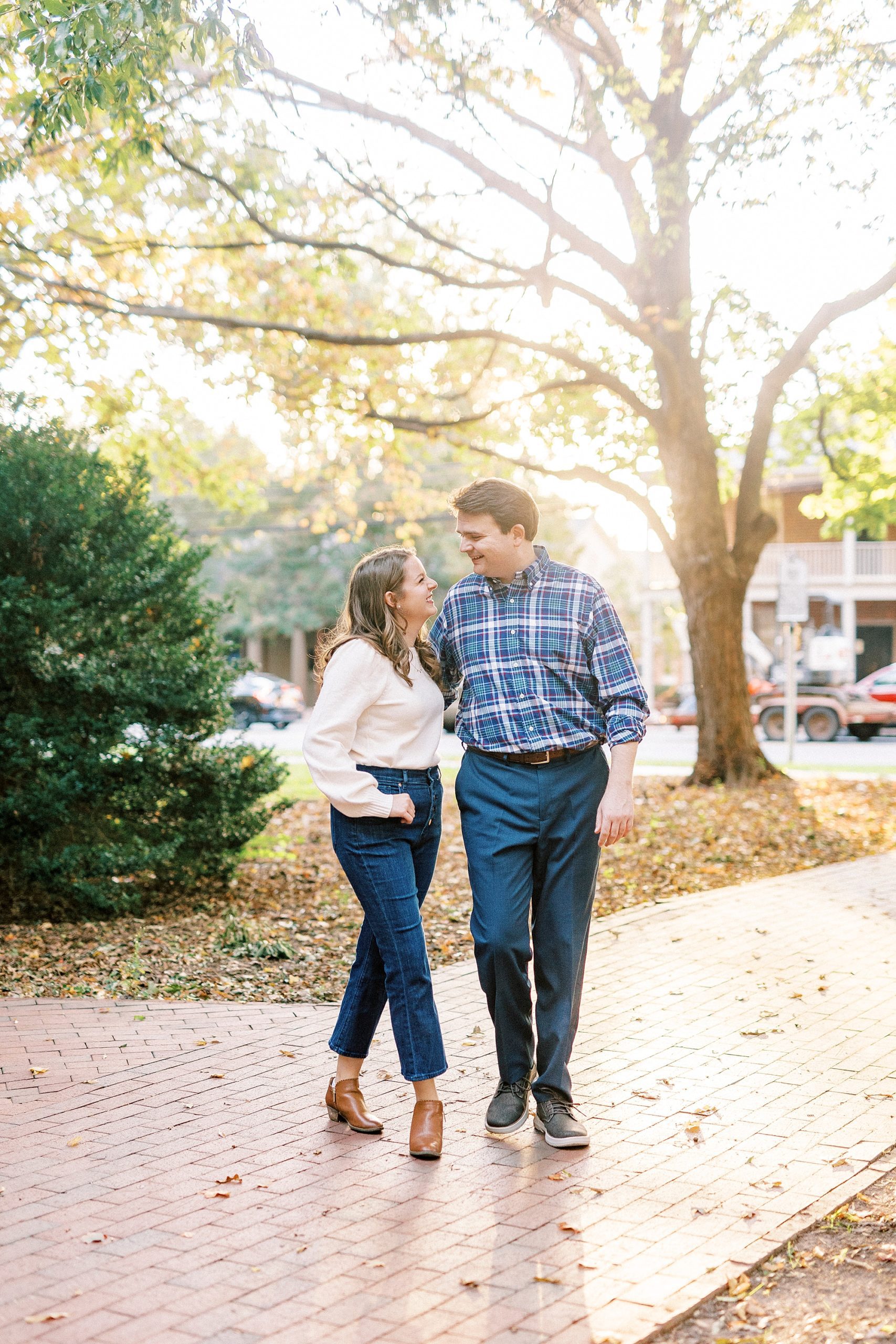 bride and groom pose on brick walkway in Downtown Davidson
