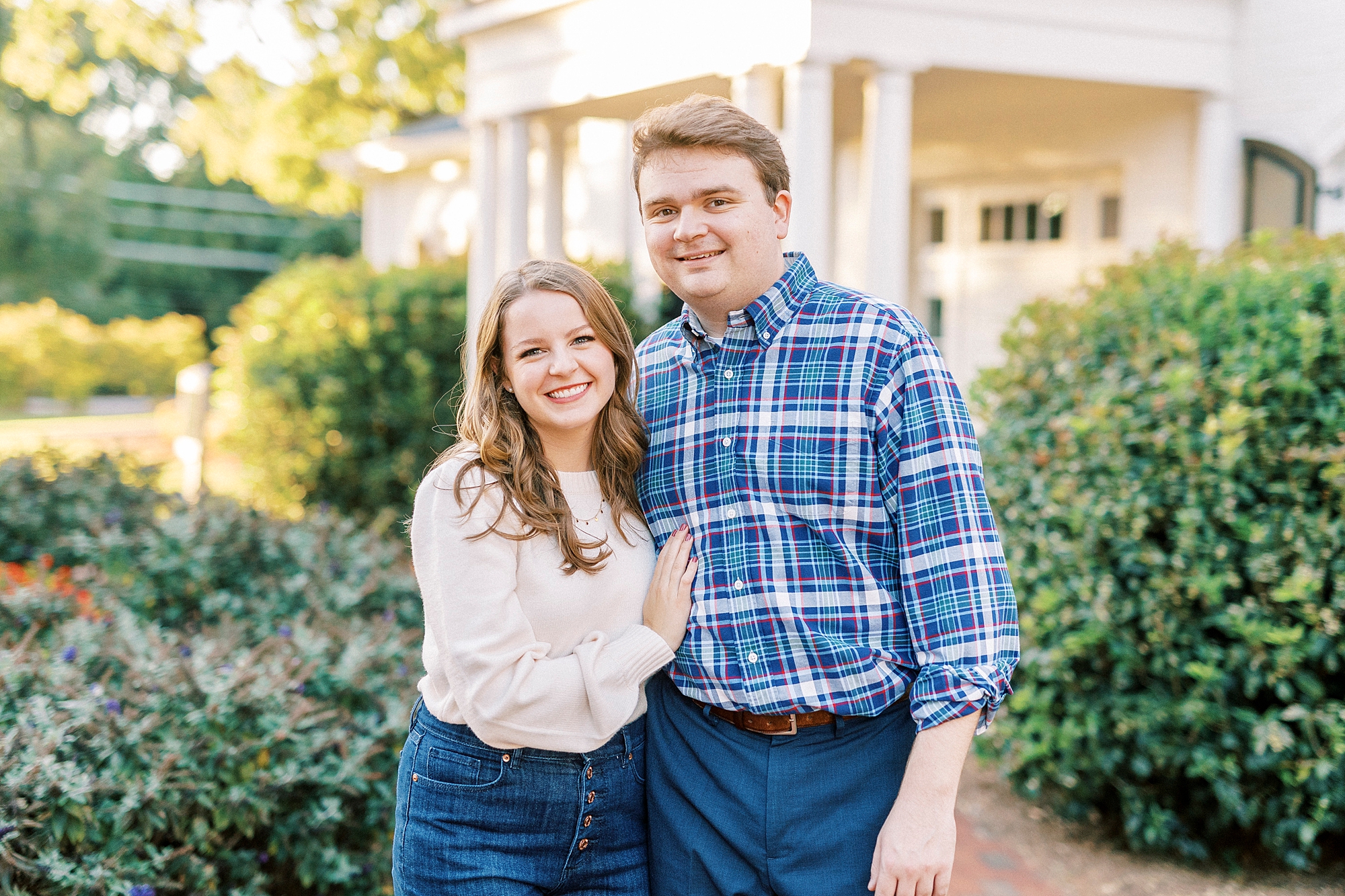 bride and groom hug among hedges in Davidson NC