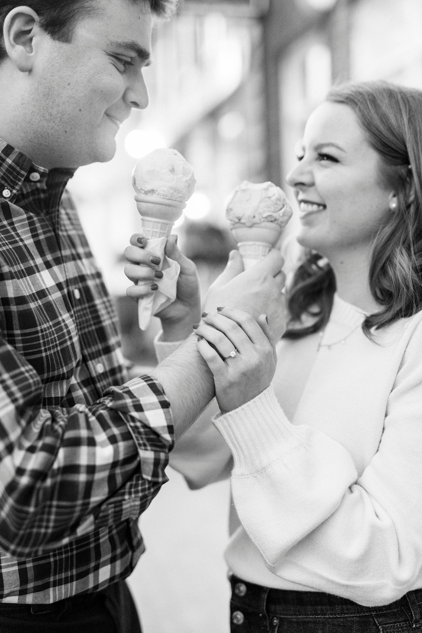 bride and groom share ice cream in Downtown Davidson