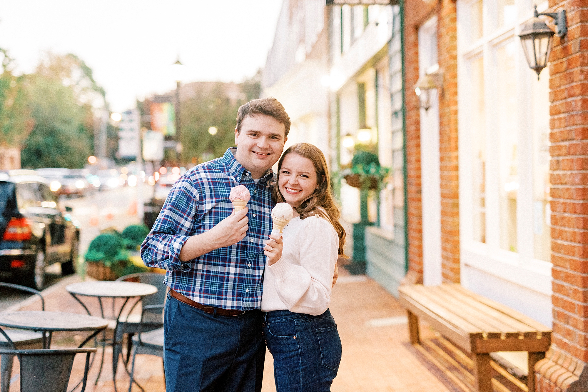 engaged couple hugs with ice cream outside Downtown Davidson shop