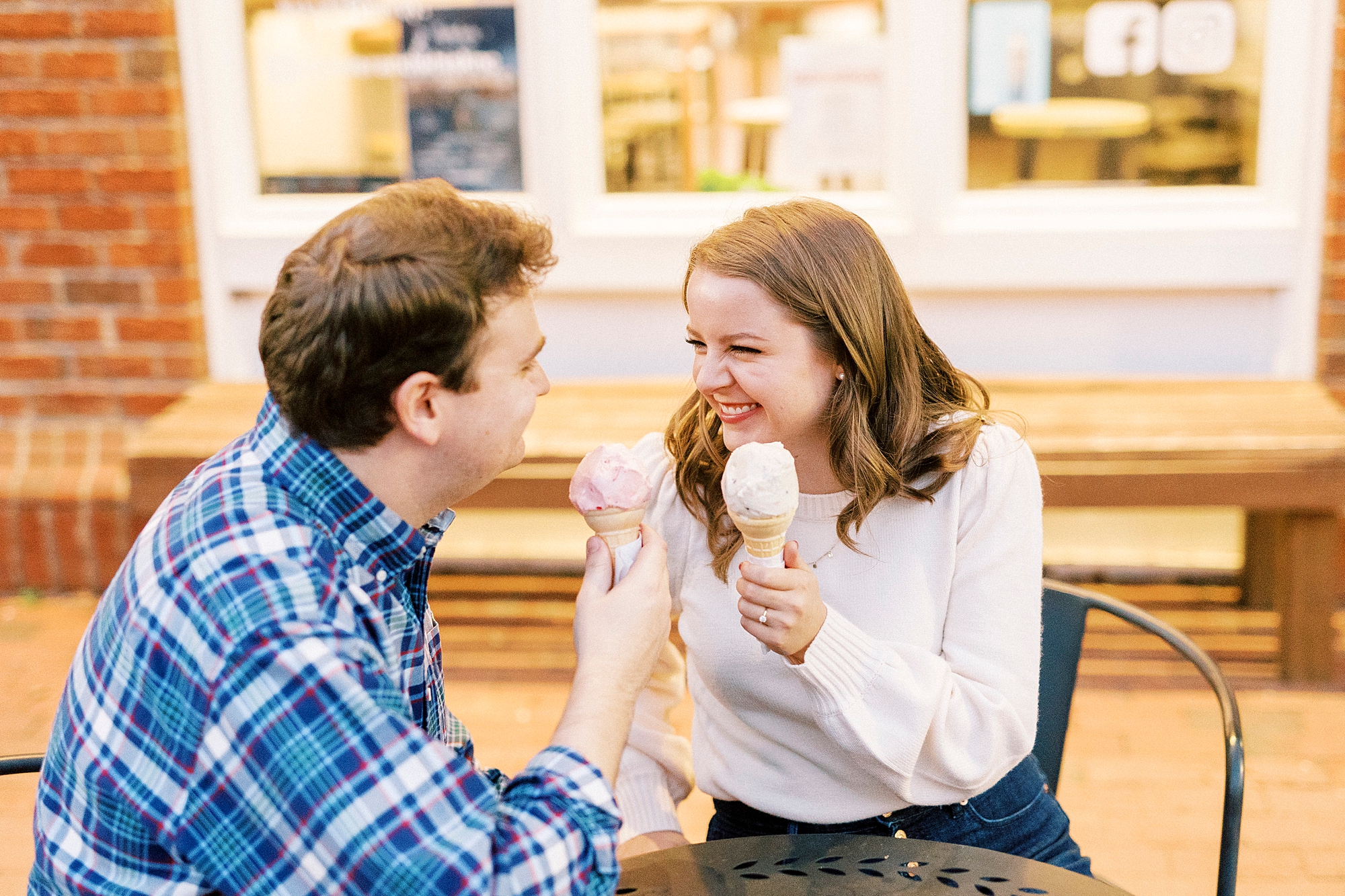 bride and groom laugh during Downtown Davidson engagement session with ice cream