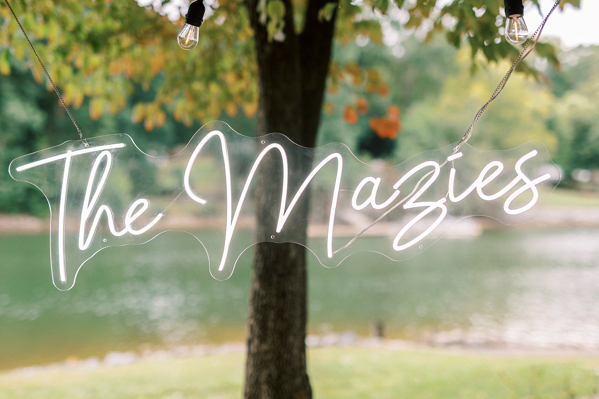 custom neon sign hanging by water for Lake Norman wedding ceremony
