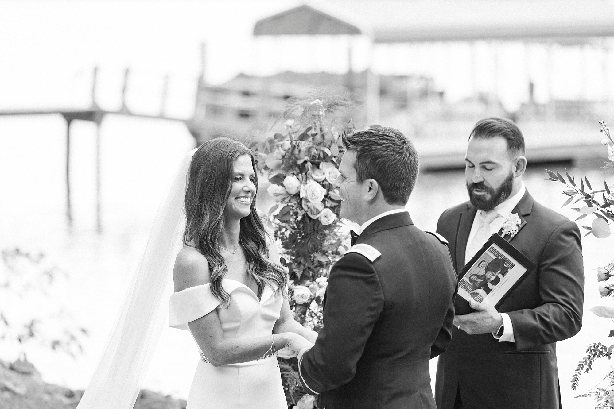 bride and groom smile exchanging vows during intimate Lake Norman wedding ceremony